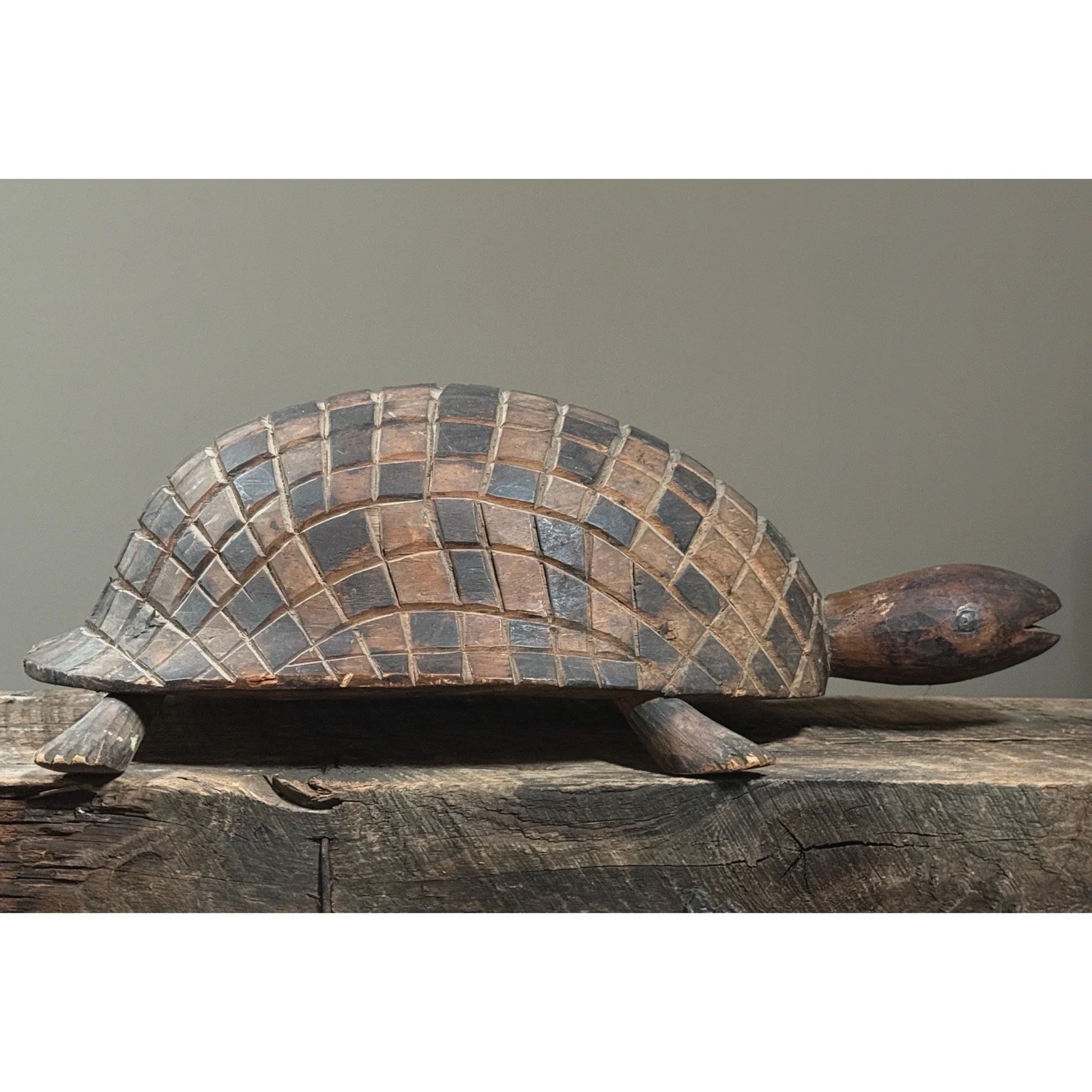Folk art turtle carving with geometric shell design