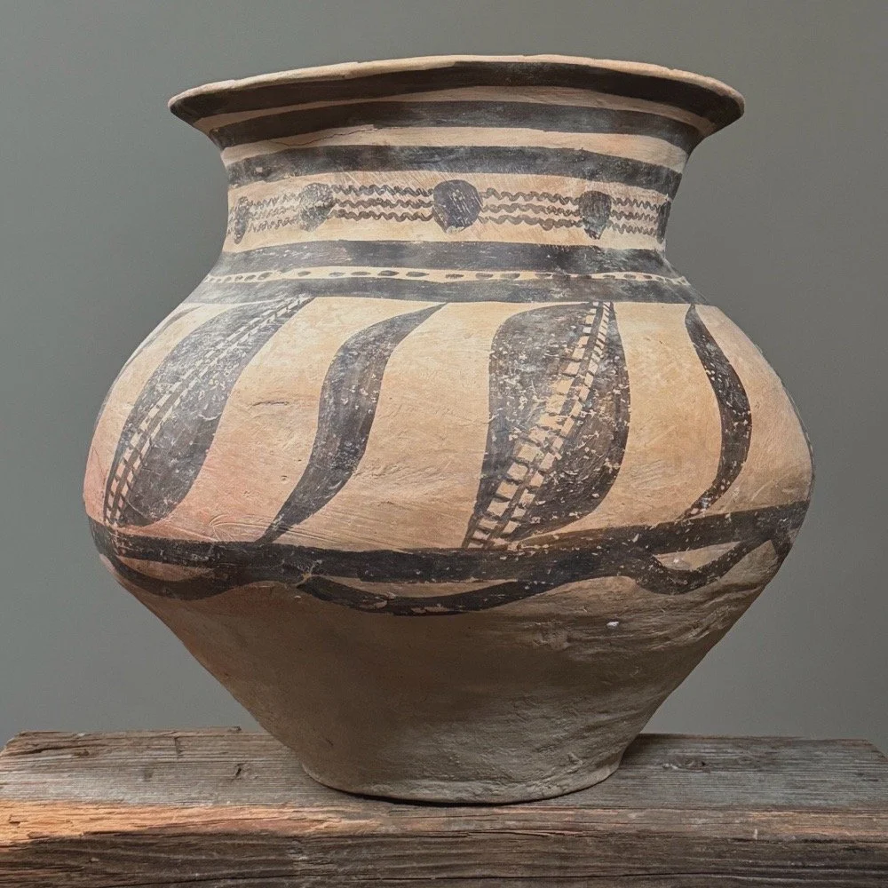 A large pottery jar in the Majiayao style with black geometric patterns.