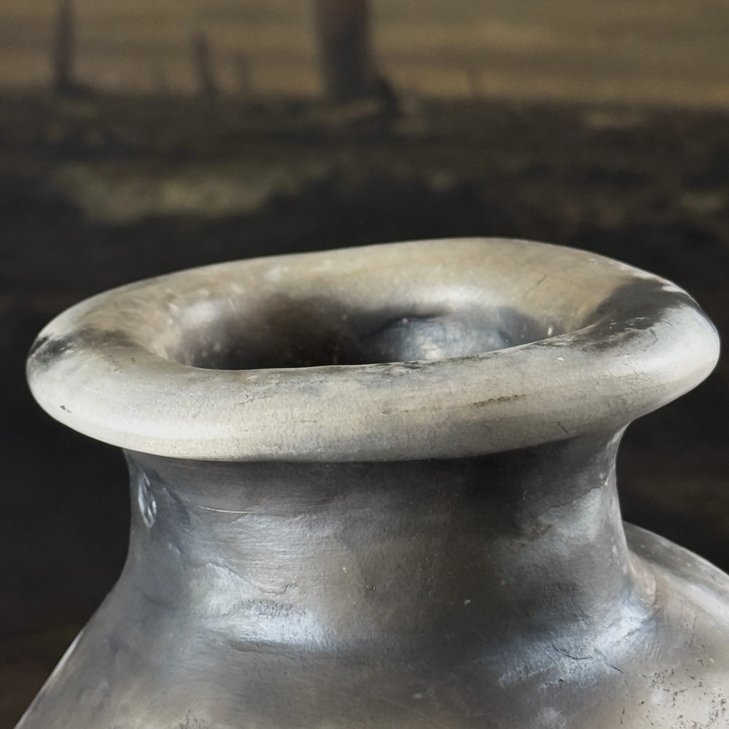 Vintage raku fired vessel with hole in center, signed with maker's mark