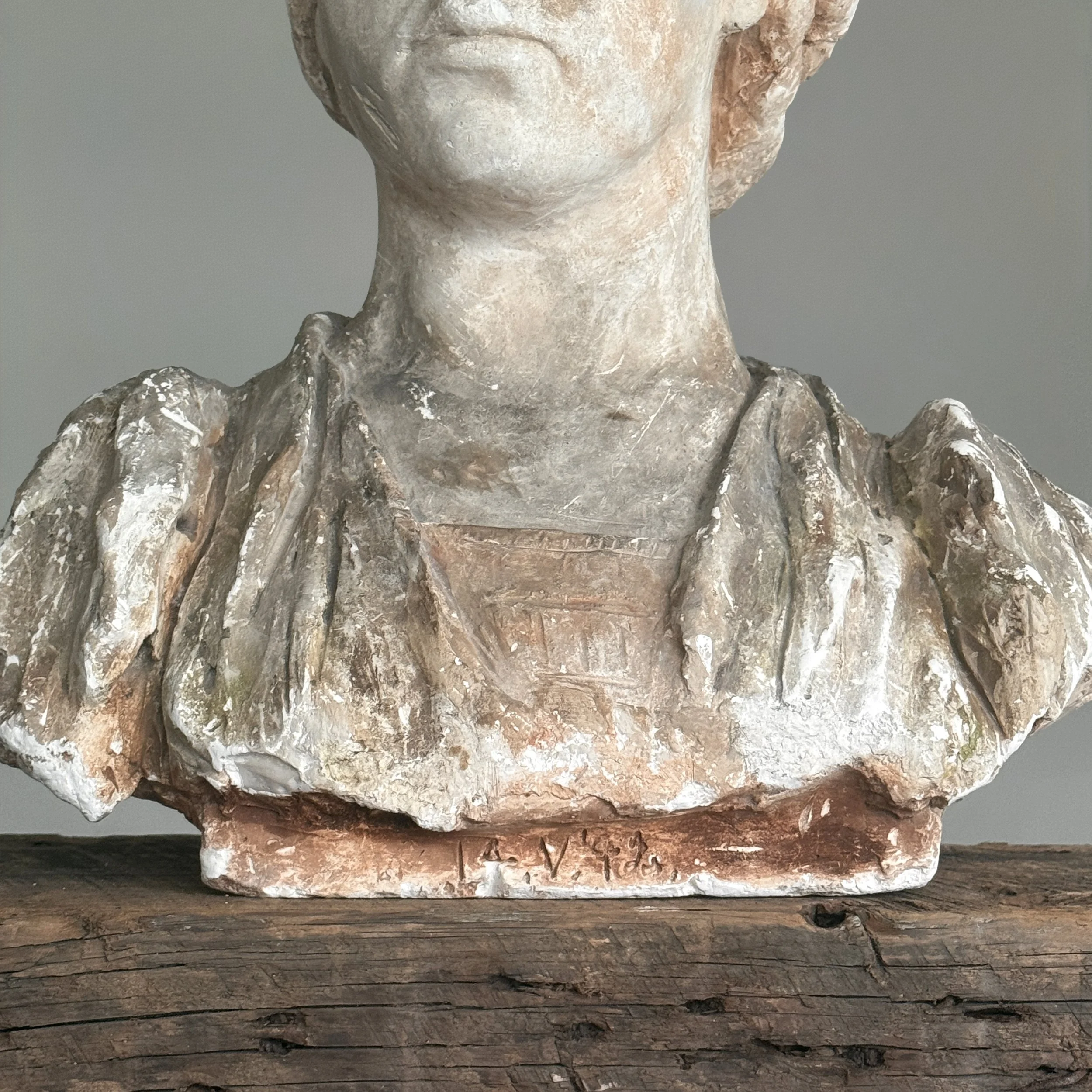 Faint illegible markings across base of antique bust