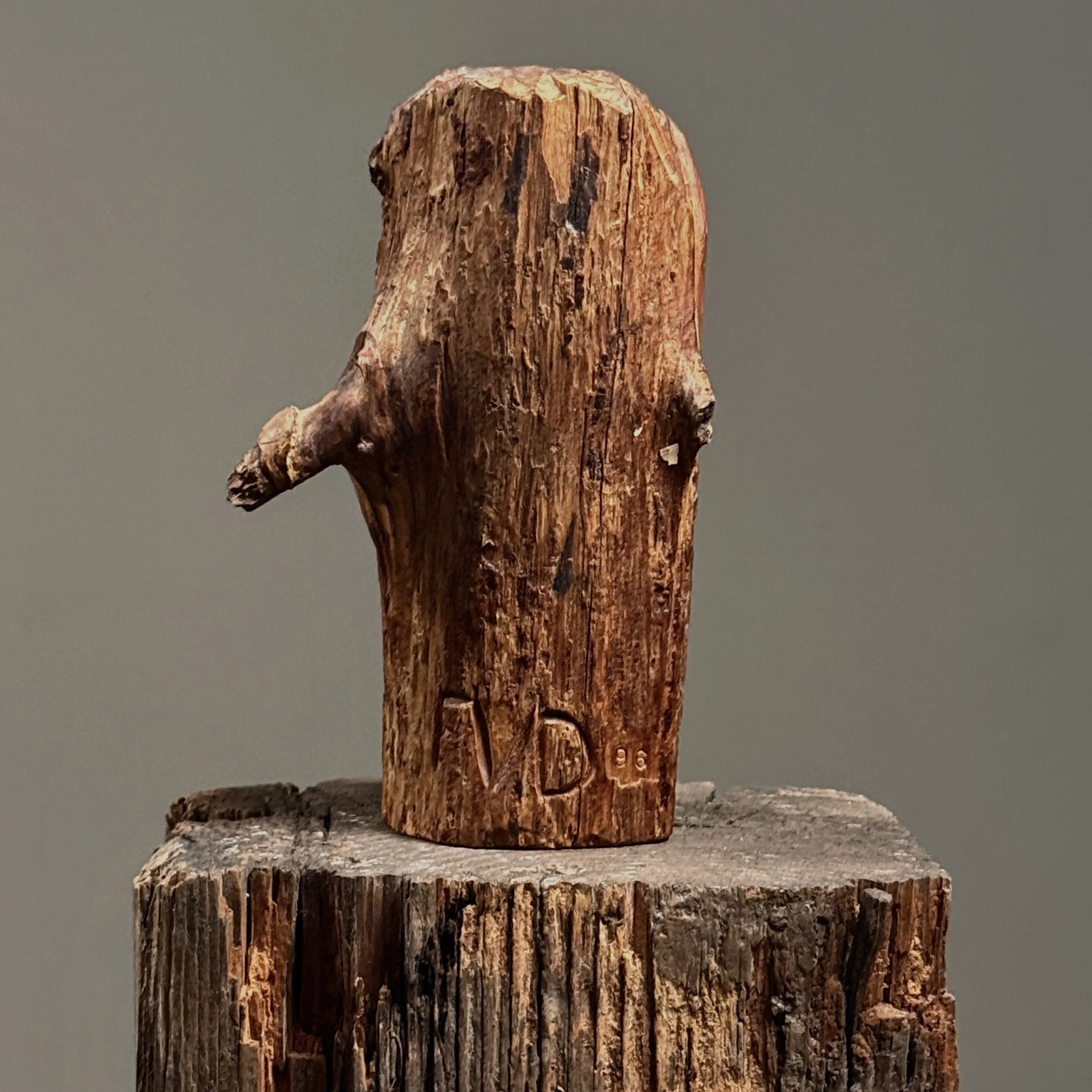Reverse with etched initials, hand-carved wood portrait