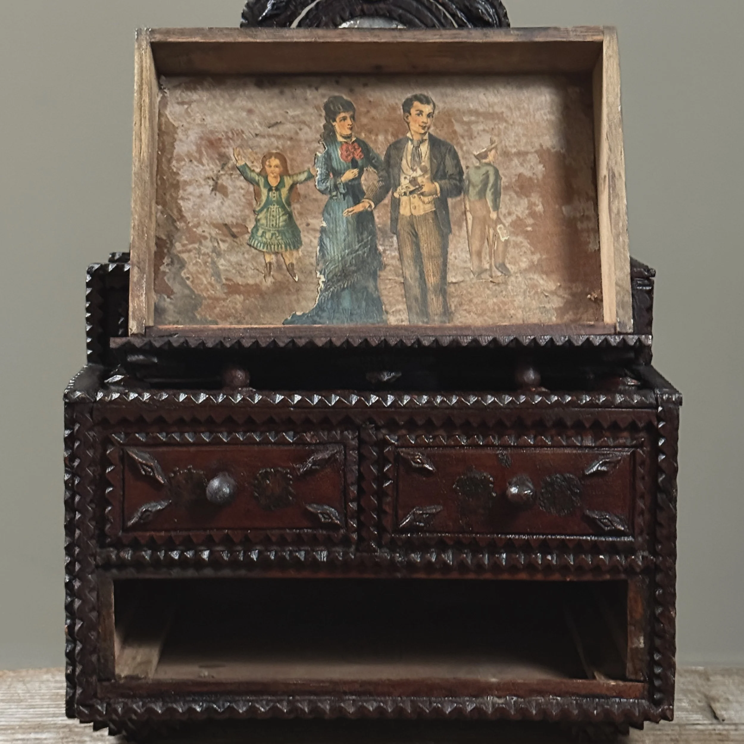 Interior view of large bottom drawer with decoupage elements visible