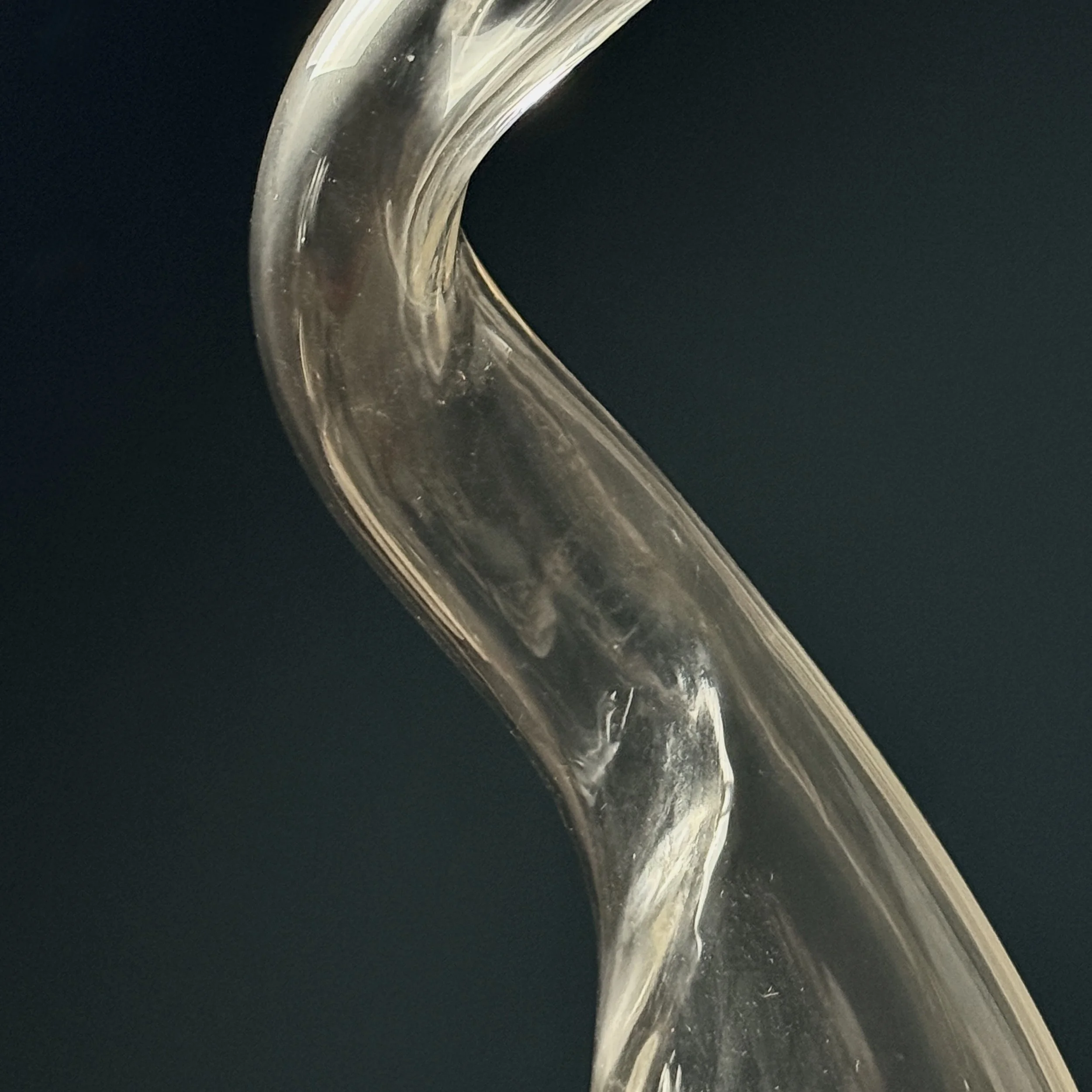 Side profile of postmodern biomorphic glass sculpture highlighting thickness variations