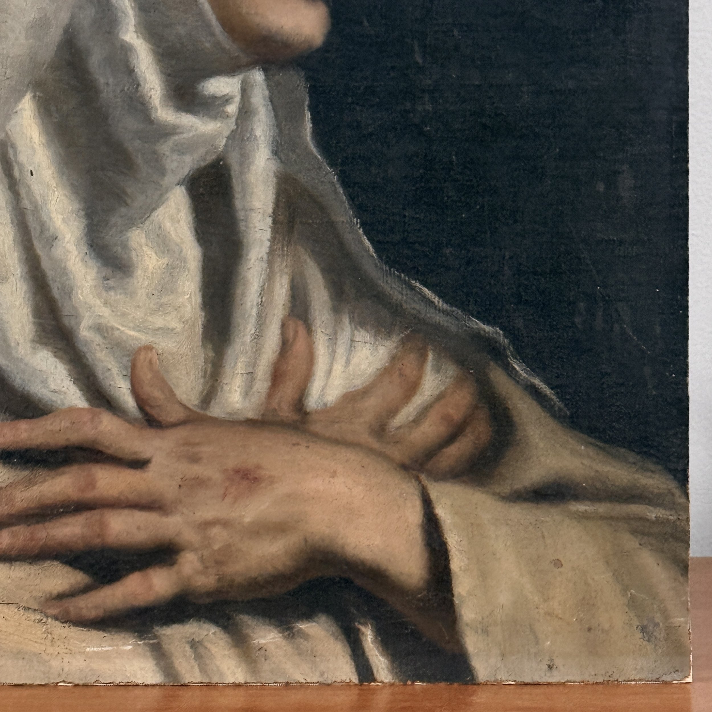 Detail view of folded hands displaying stigmata on Saint Catherine of Siena, antique oil portrait on board