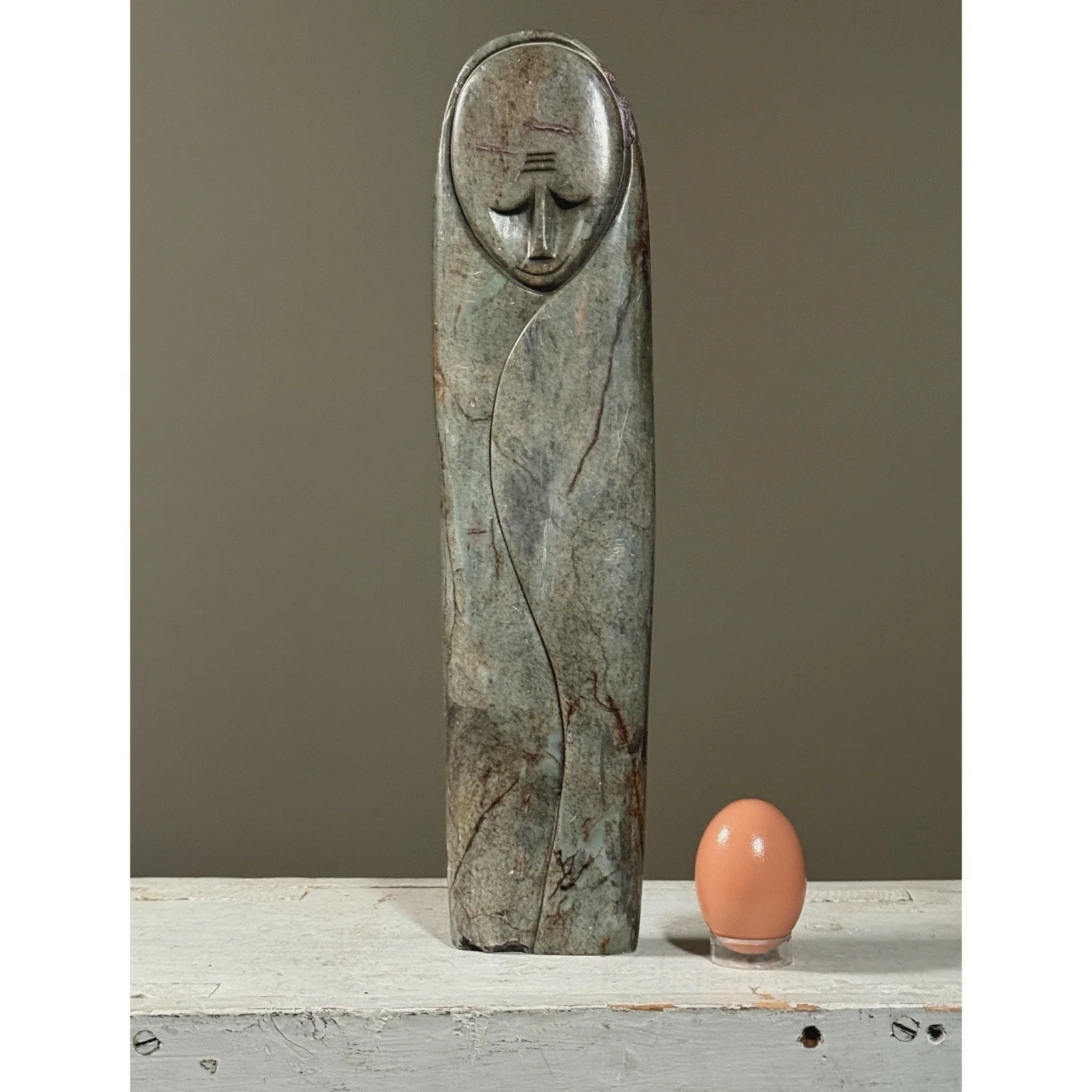 Vintage grey serpentine stone Shona sculpture with egg for size reference.