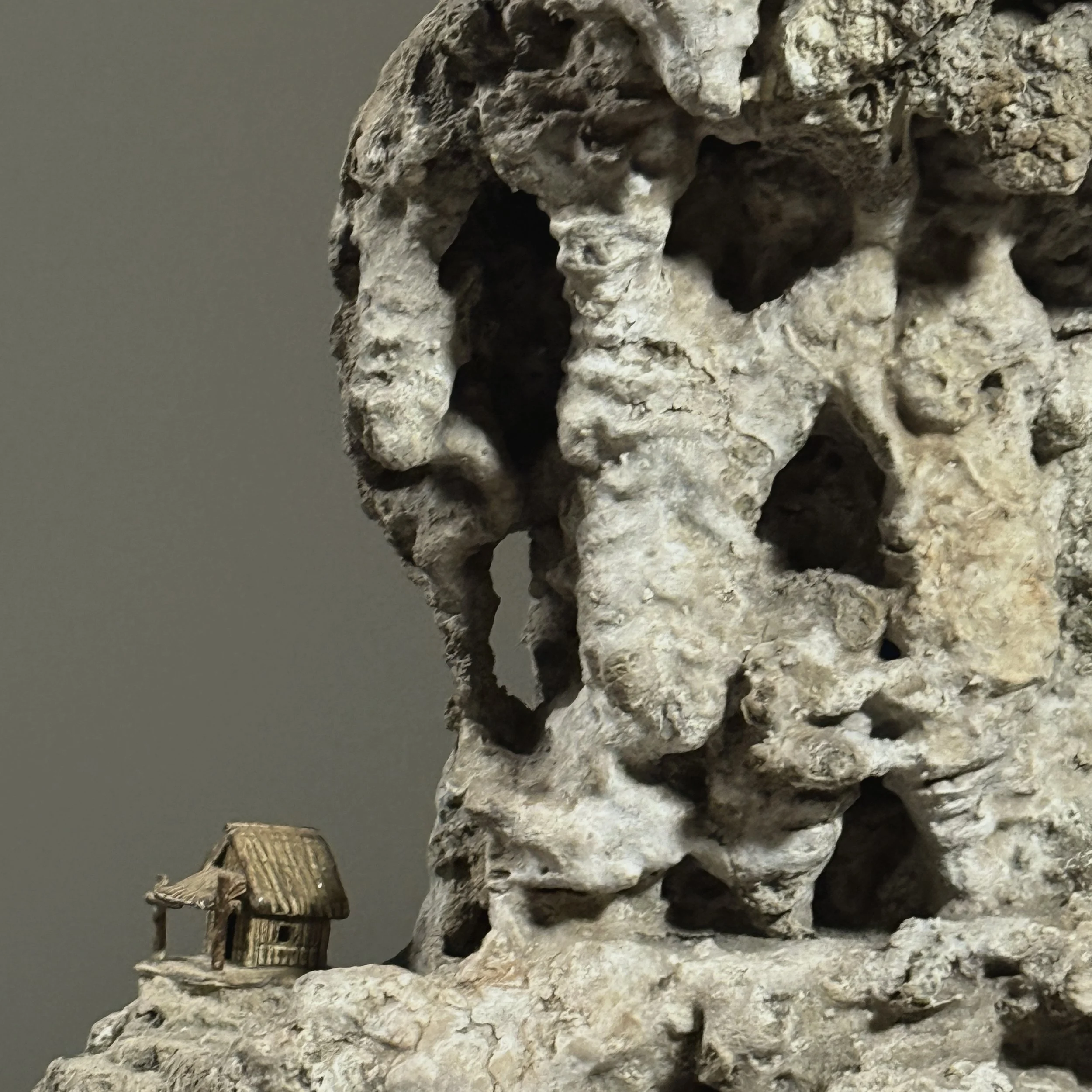 Close-up of porcelain houses on Suiseki stone surface
