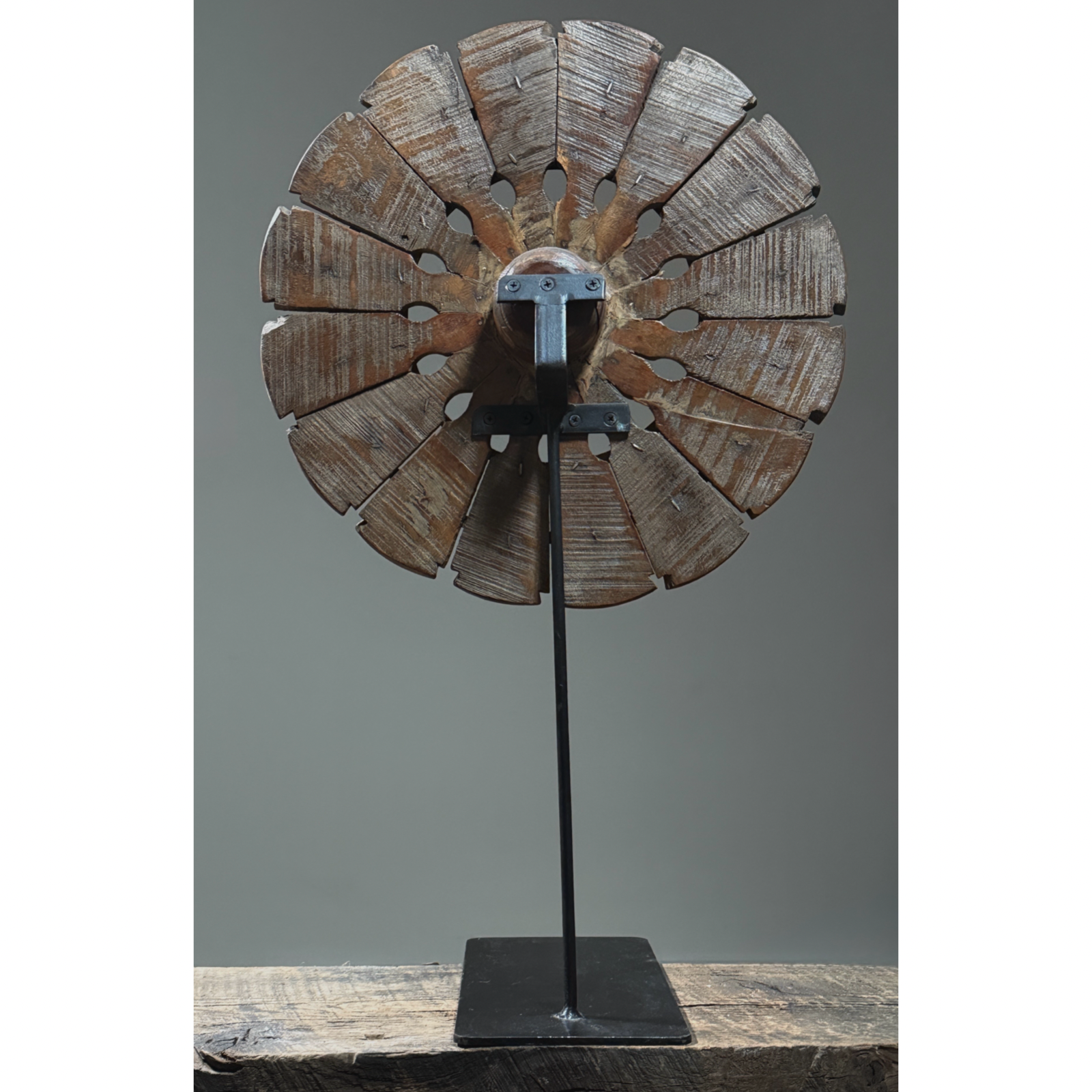 Back view of Antique hand carved folk art charkha wheel. Traditional Indian spinning wheel. 27 inches high.