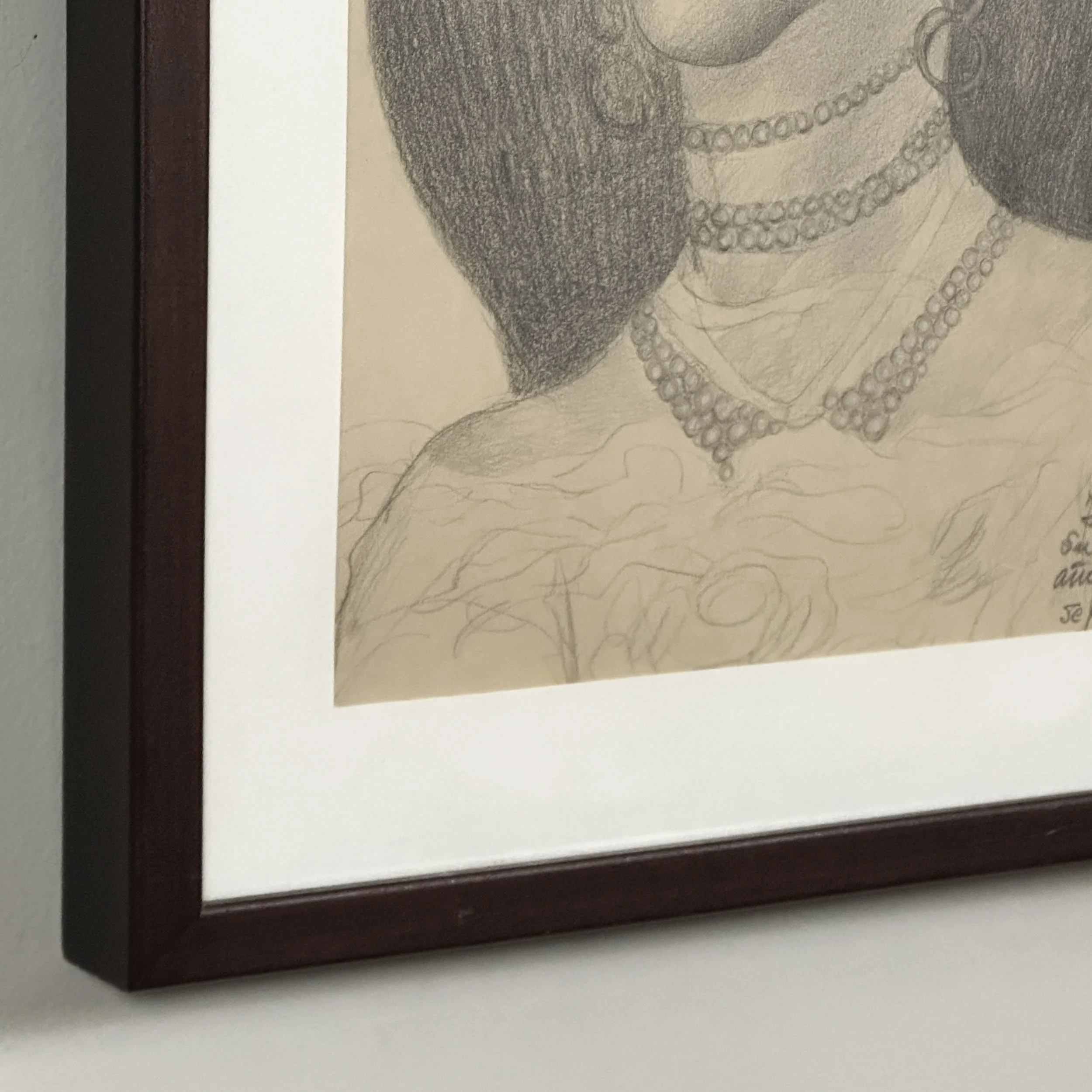 Side view of the framed drawing, showing its depth under glass.