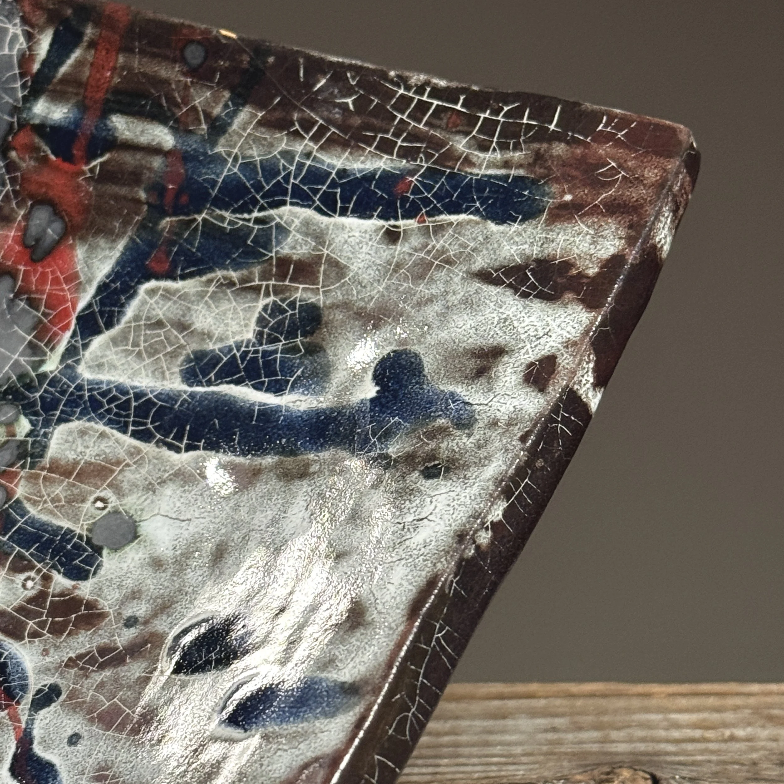 Detail of splatter glaze. Abstract Expressionist gesture. Blue and red pigment application.
