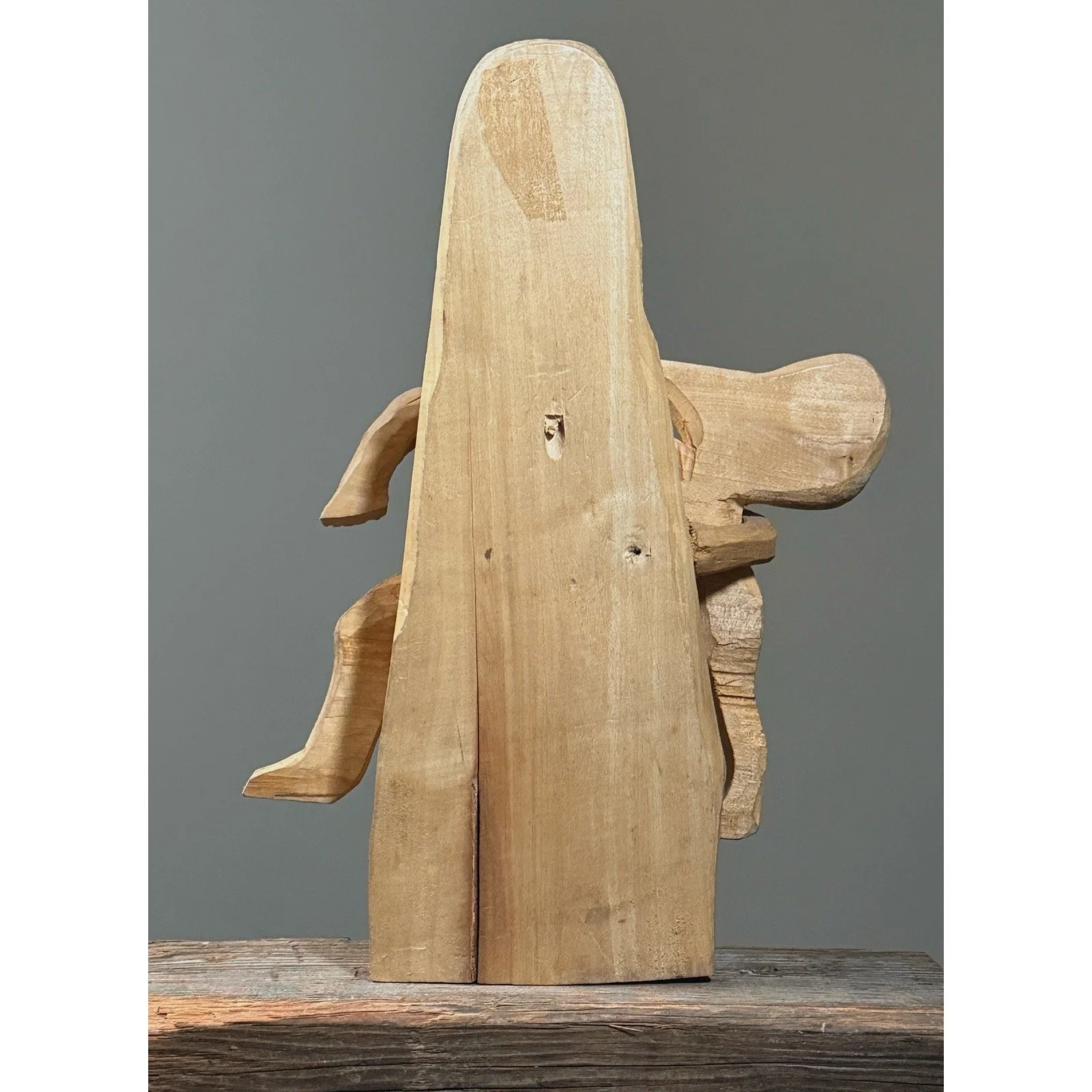 Rear view showing the flat back of the carving