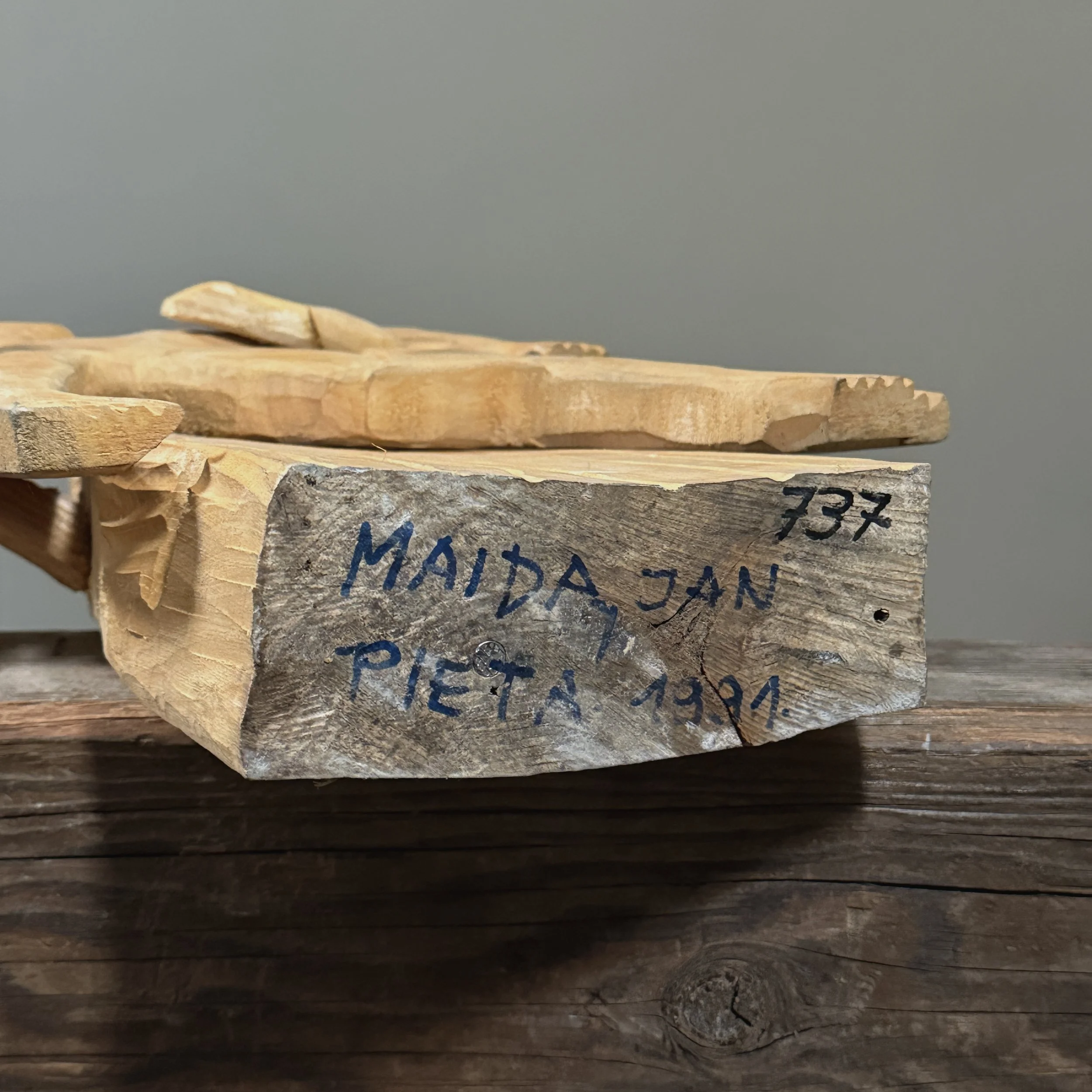 View of the sculpture's base showing the signature and date.