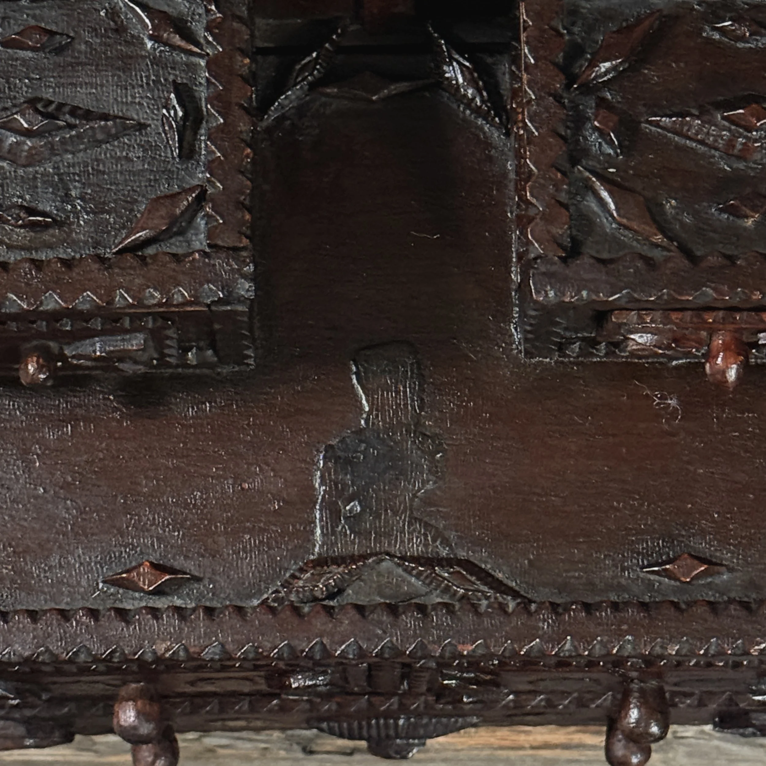 Close-up of carved appliqués on upper right corner of tramp art dresser
