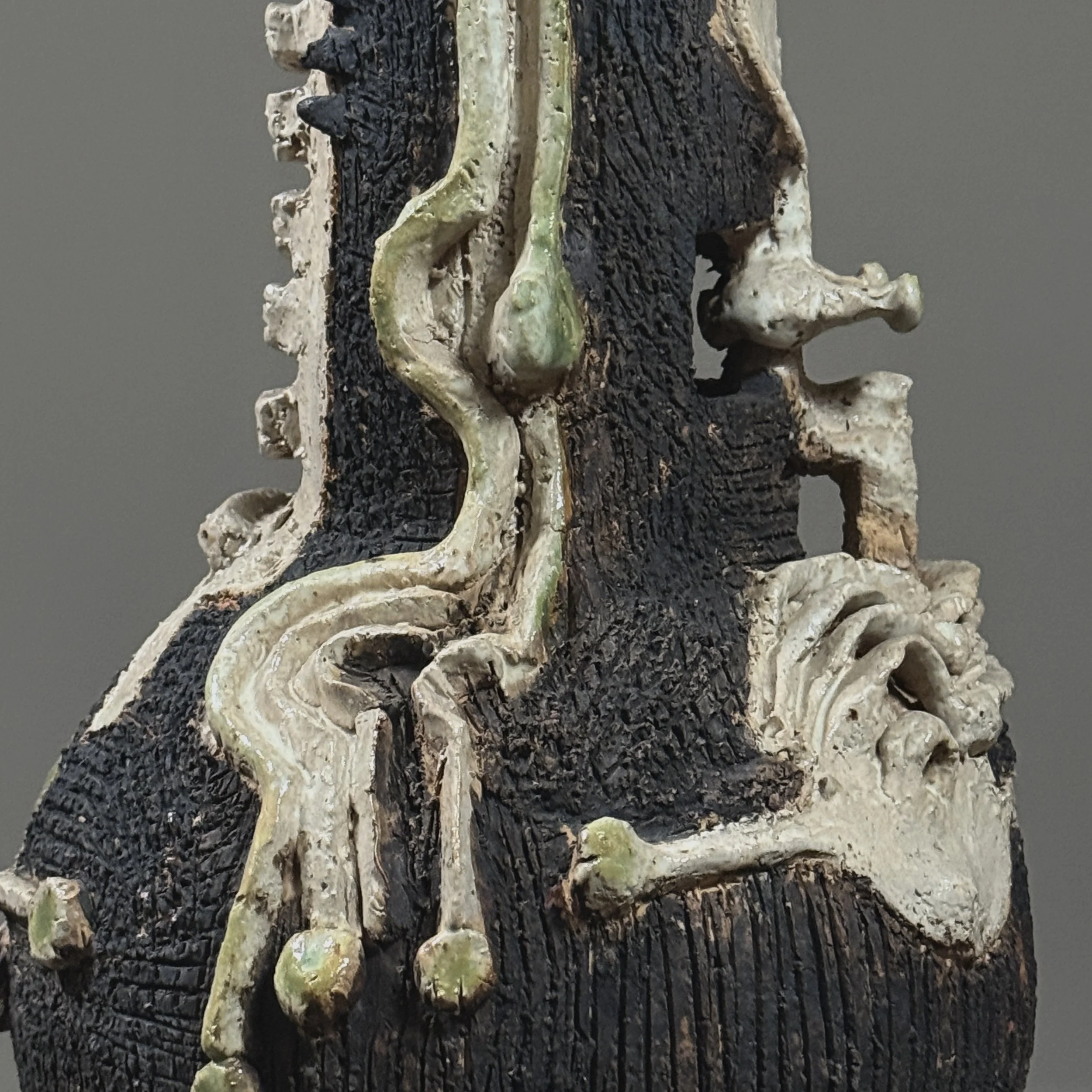 Detail showcasing the carbonized black finish from the Raku firing process.