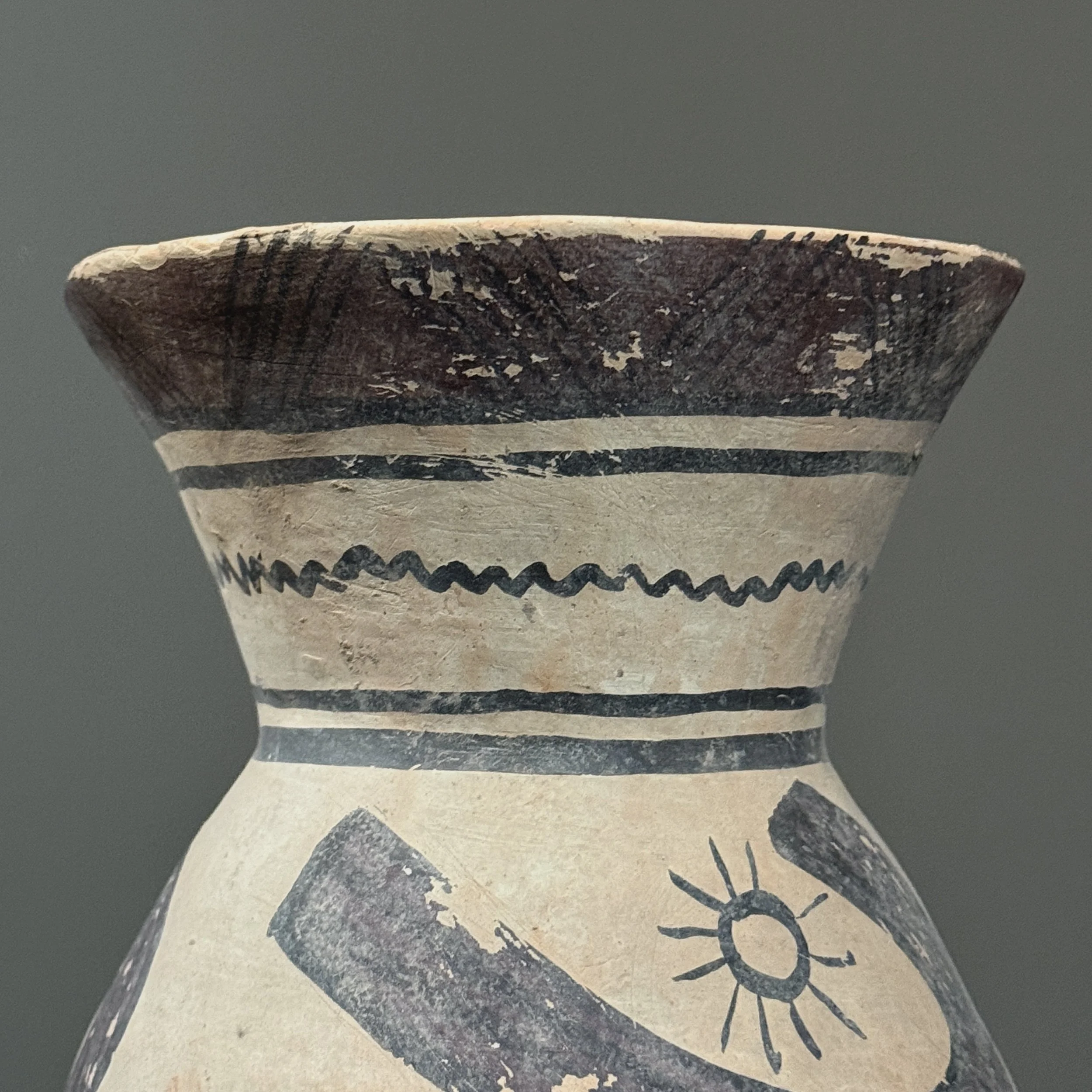 Wide flared rim with brown line detailing on antique vessel