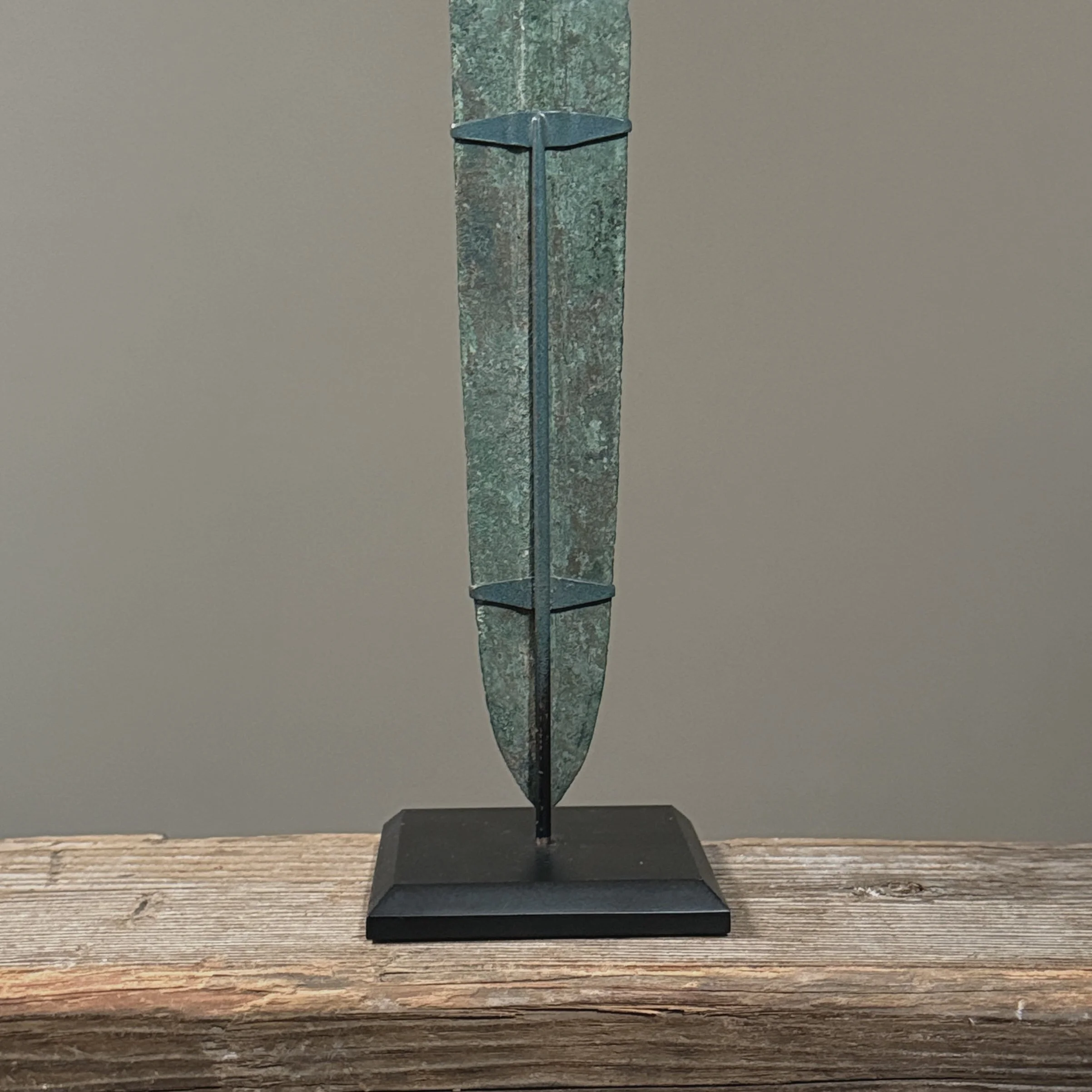 The sharp, tapered point and raised spine of the Luristan bronze blade.