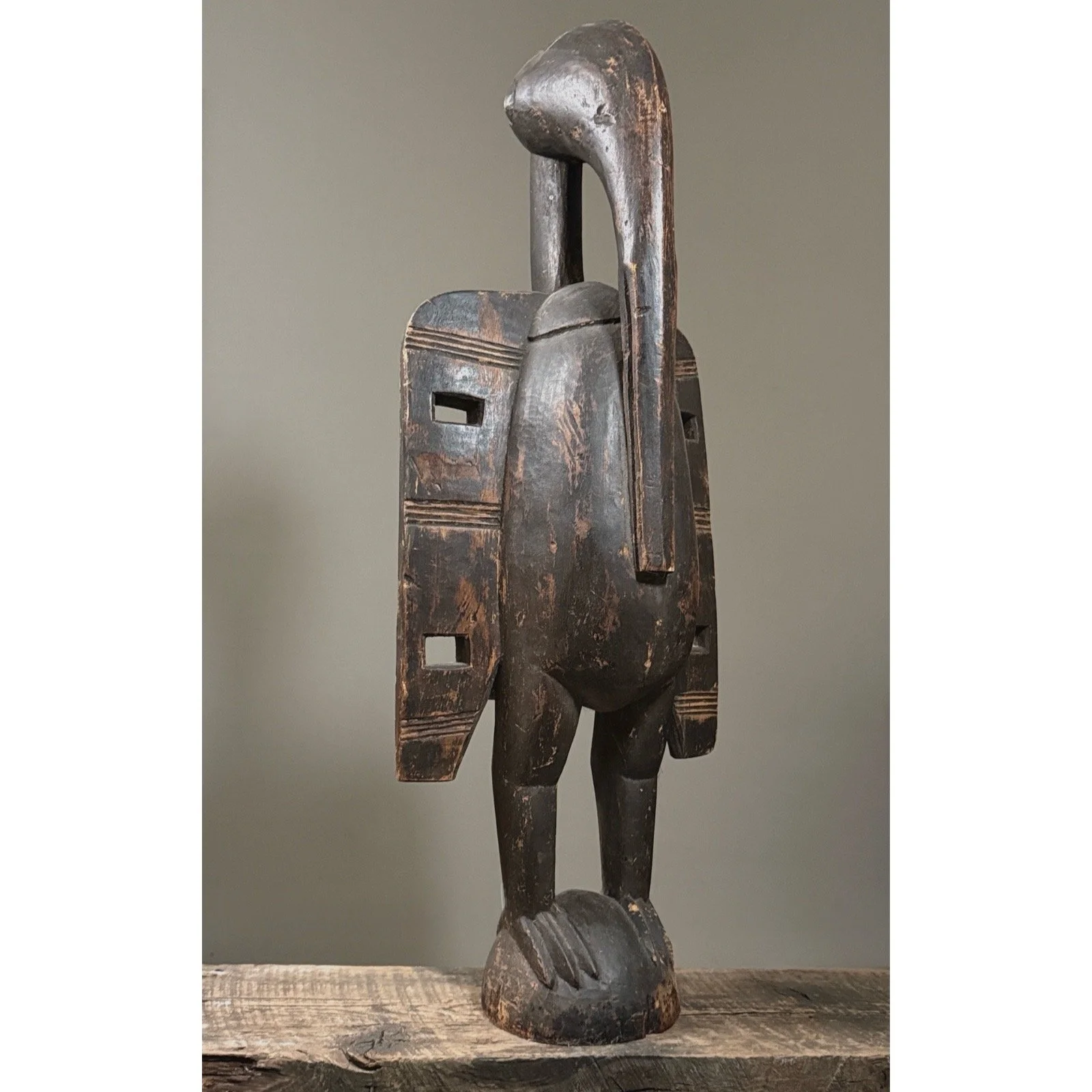 Three quarter view of hand carved African bird statue