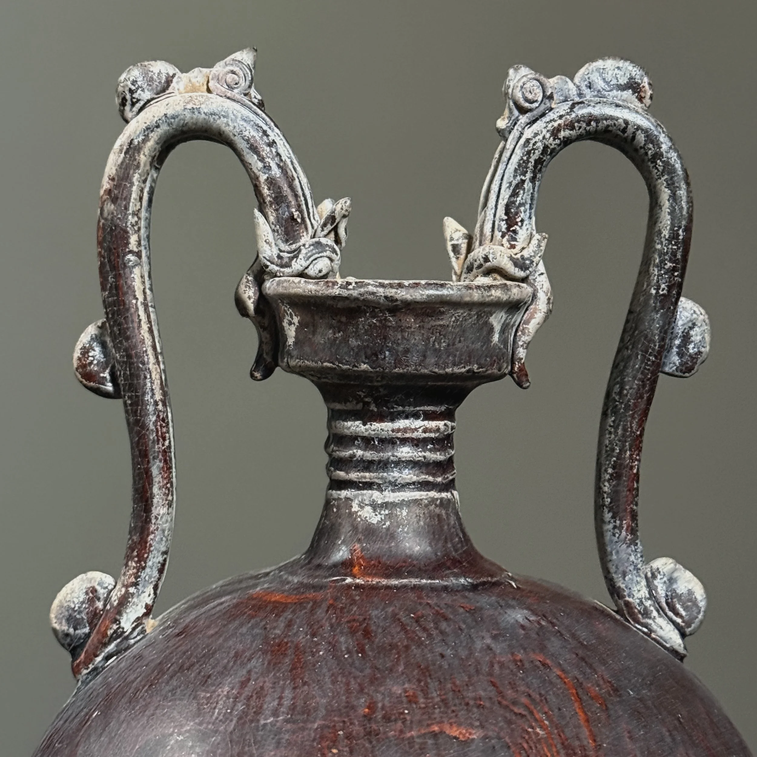Close-up of dragon-head handles on Chinese vase