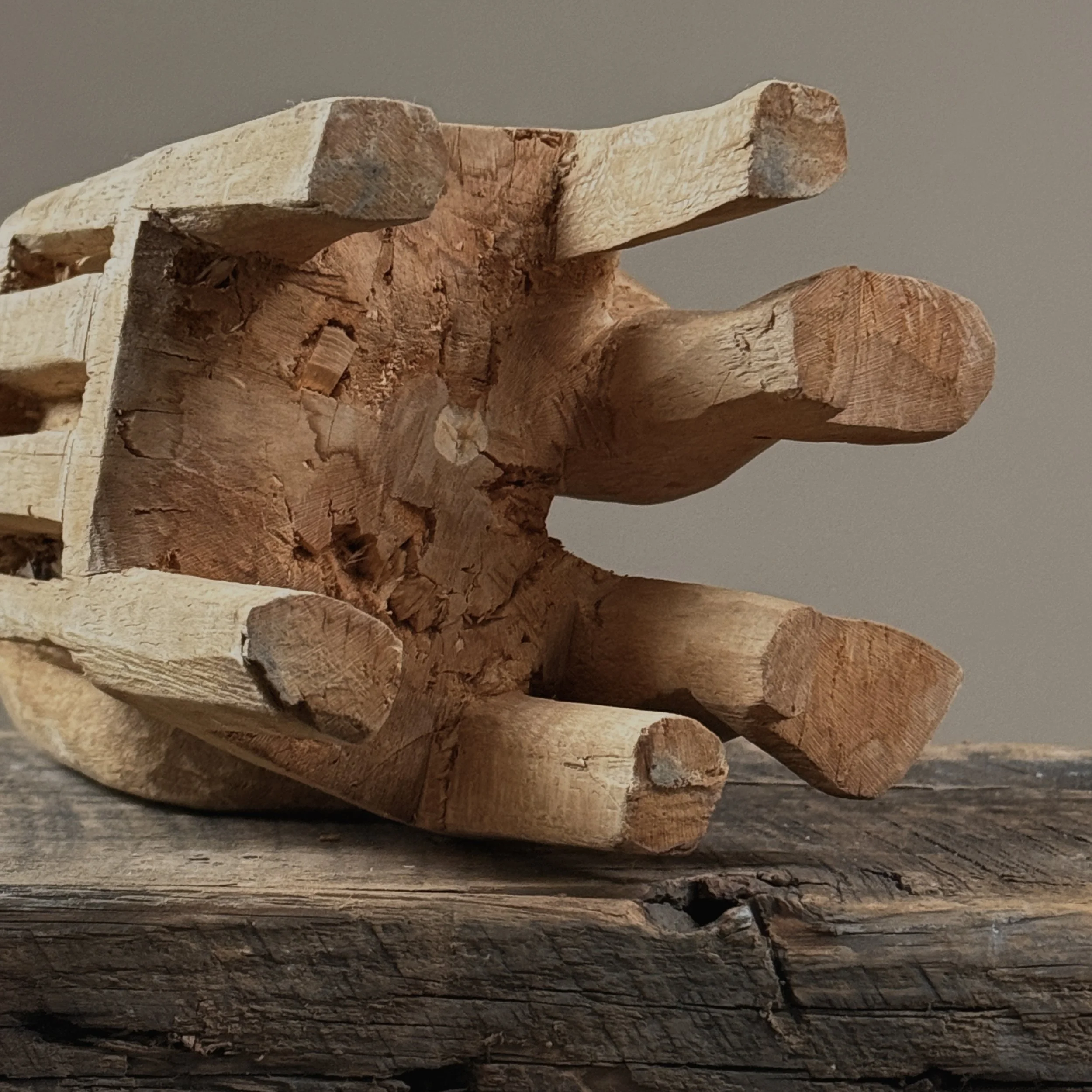 Seated posture detail, Guna nuchu, carved wood figure