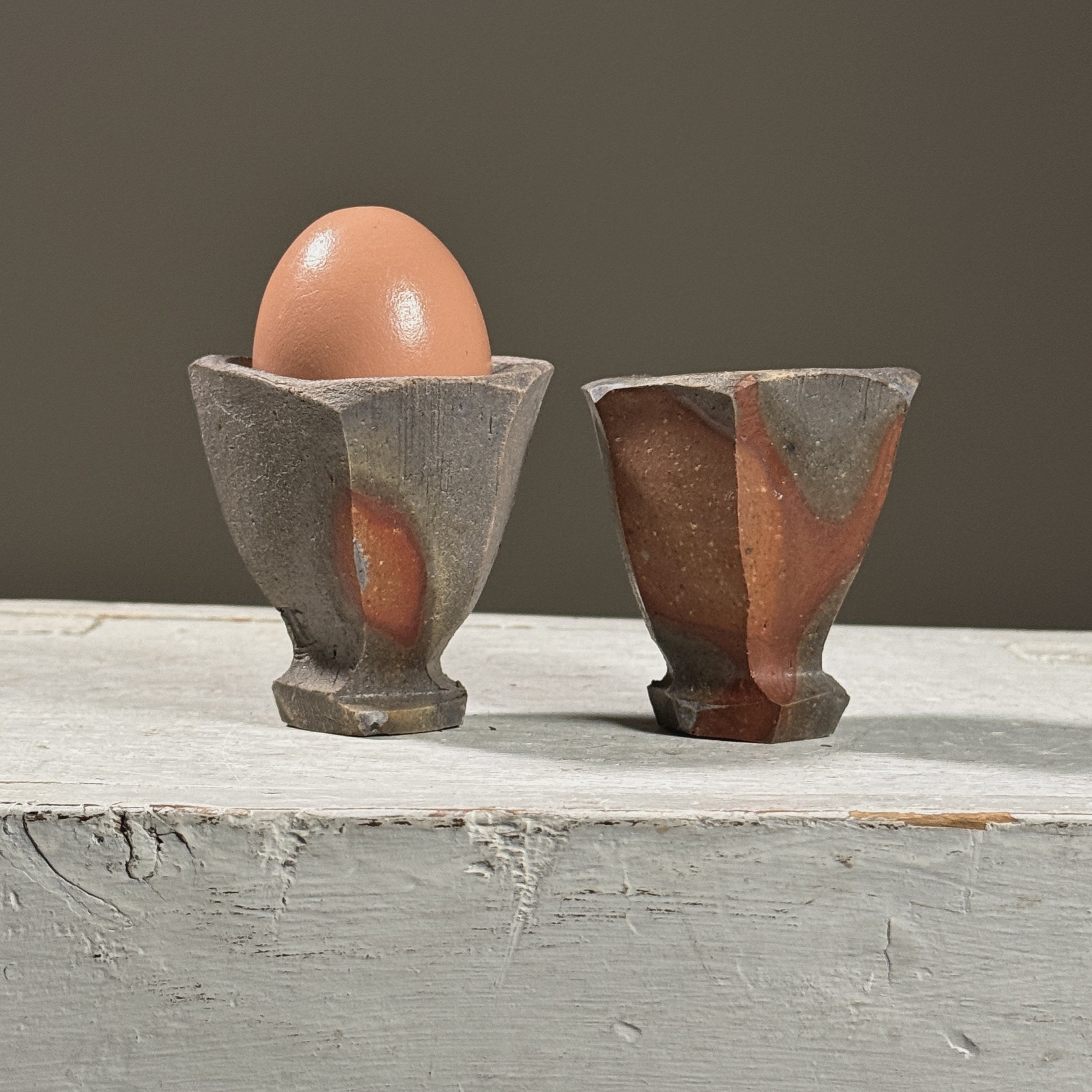 Detail of ash accumulation and kiln effects on stoneware surface.