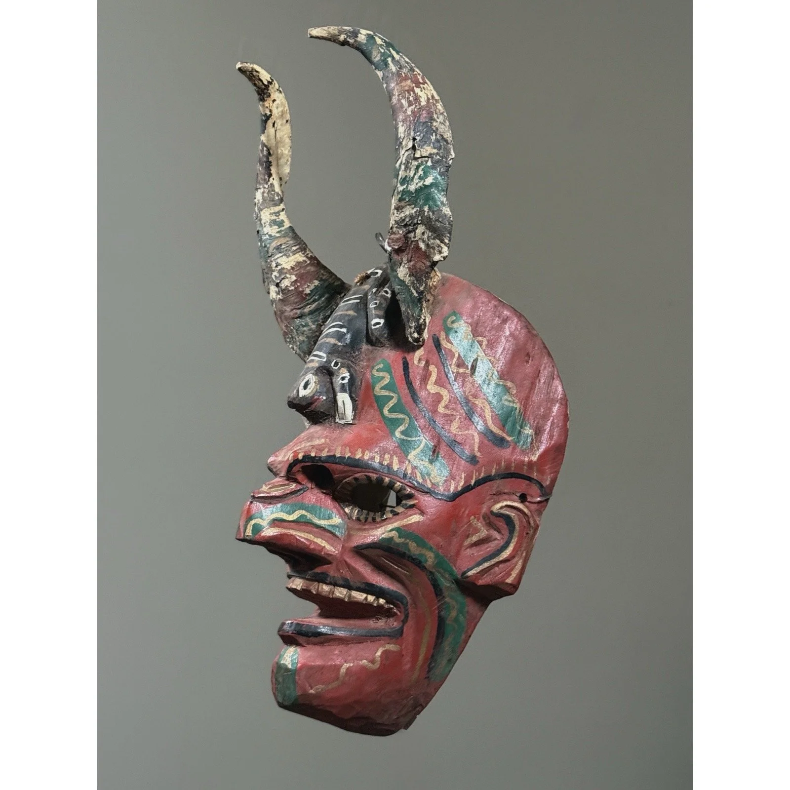 Three-quarter view showing the mask's depth and sculptural form.