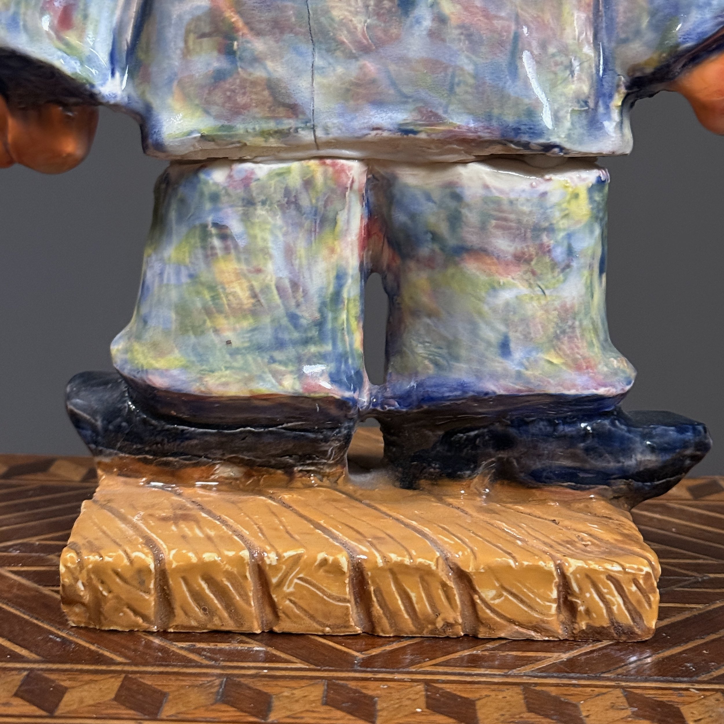 Detail of the base, showing the interface between the sculpture and its supporting surface.