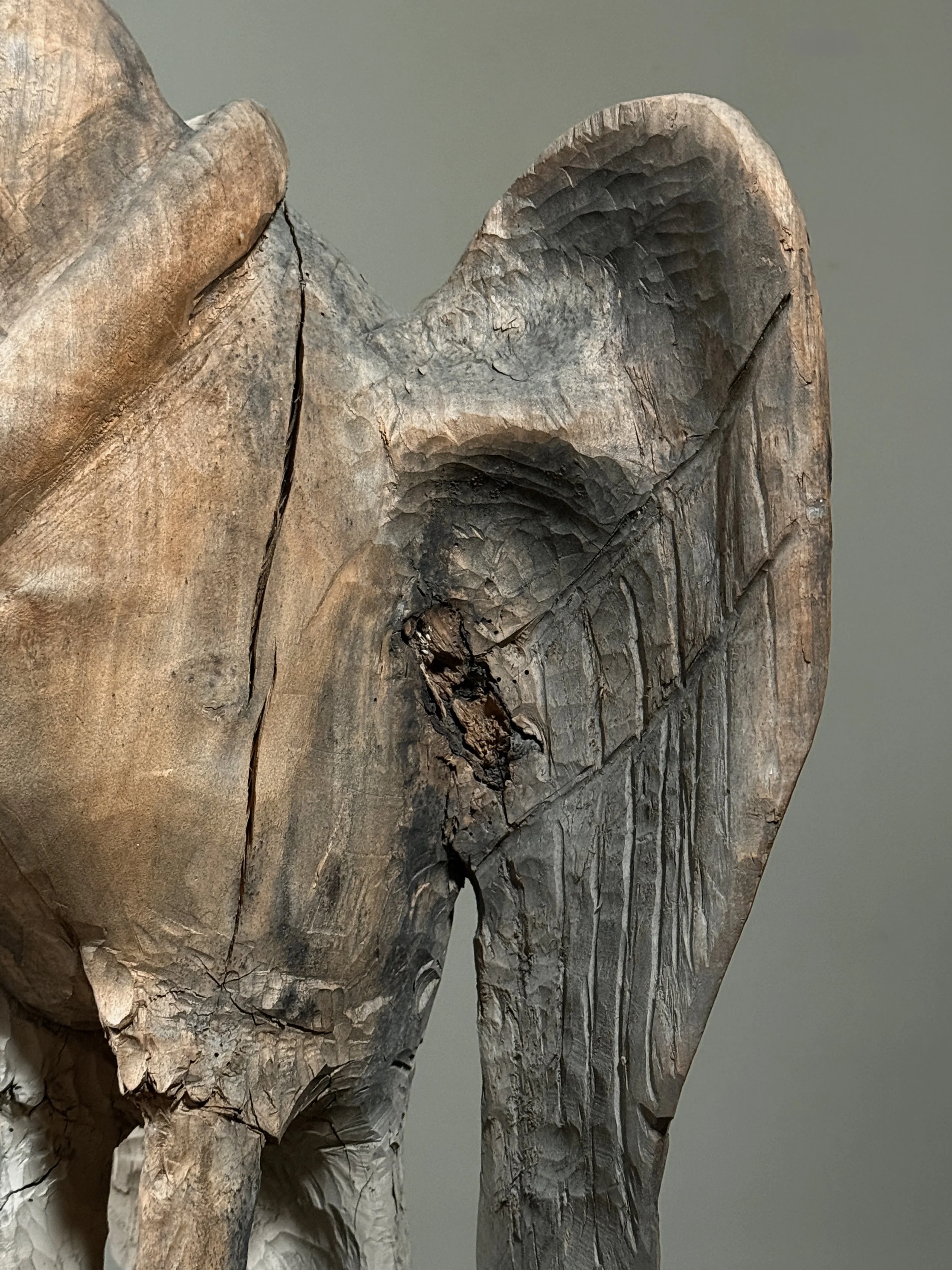 Monumental folk art bird carving wing detail