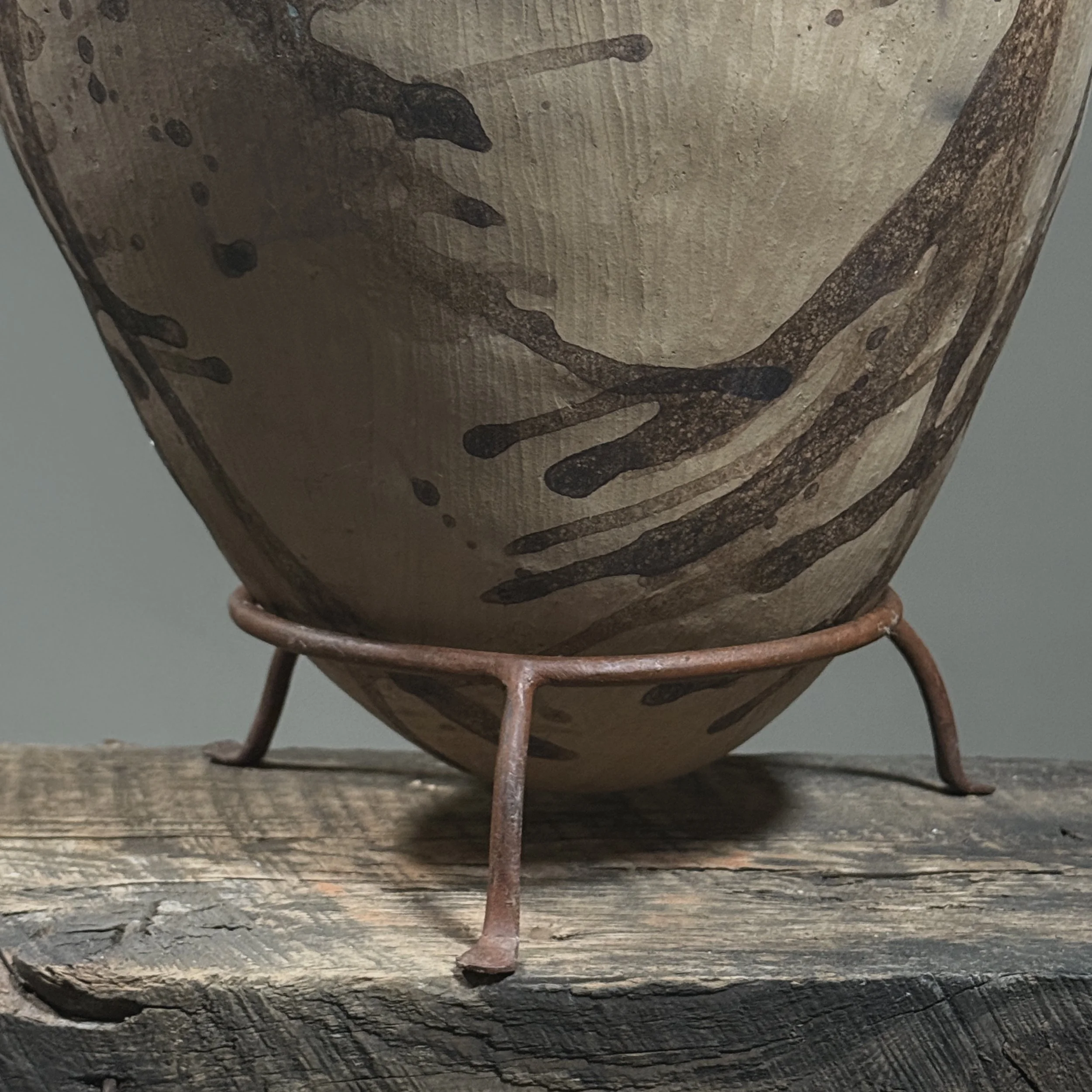 Custom metal stand supporting large Oaxacan pottery jug