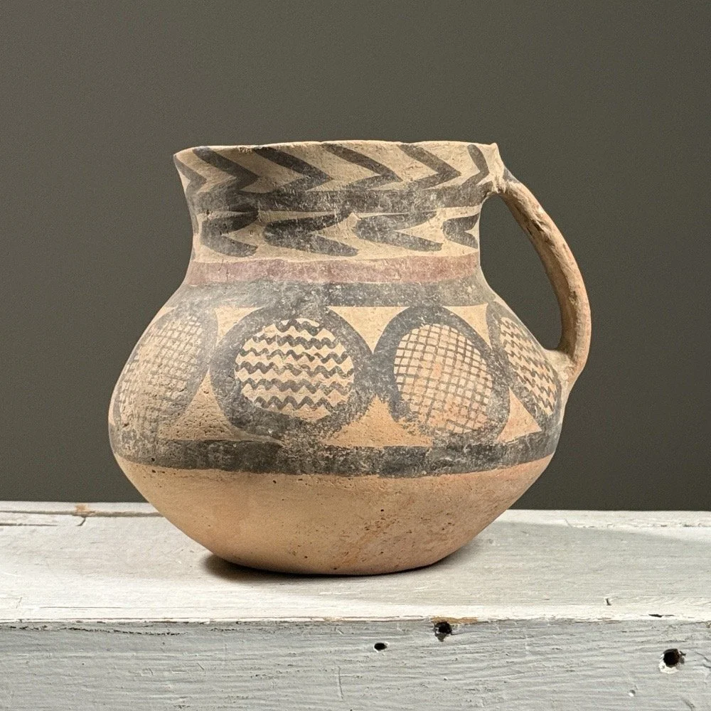 Full frontal view of a Chinese Neolithic style pottery jar with bulbous body and flaring neck