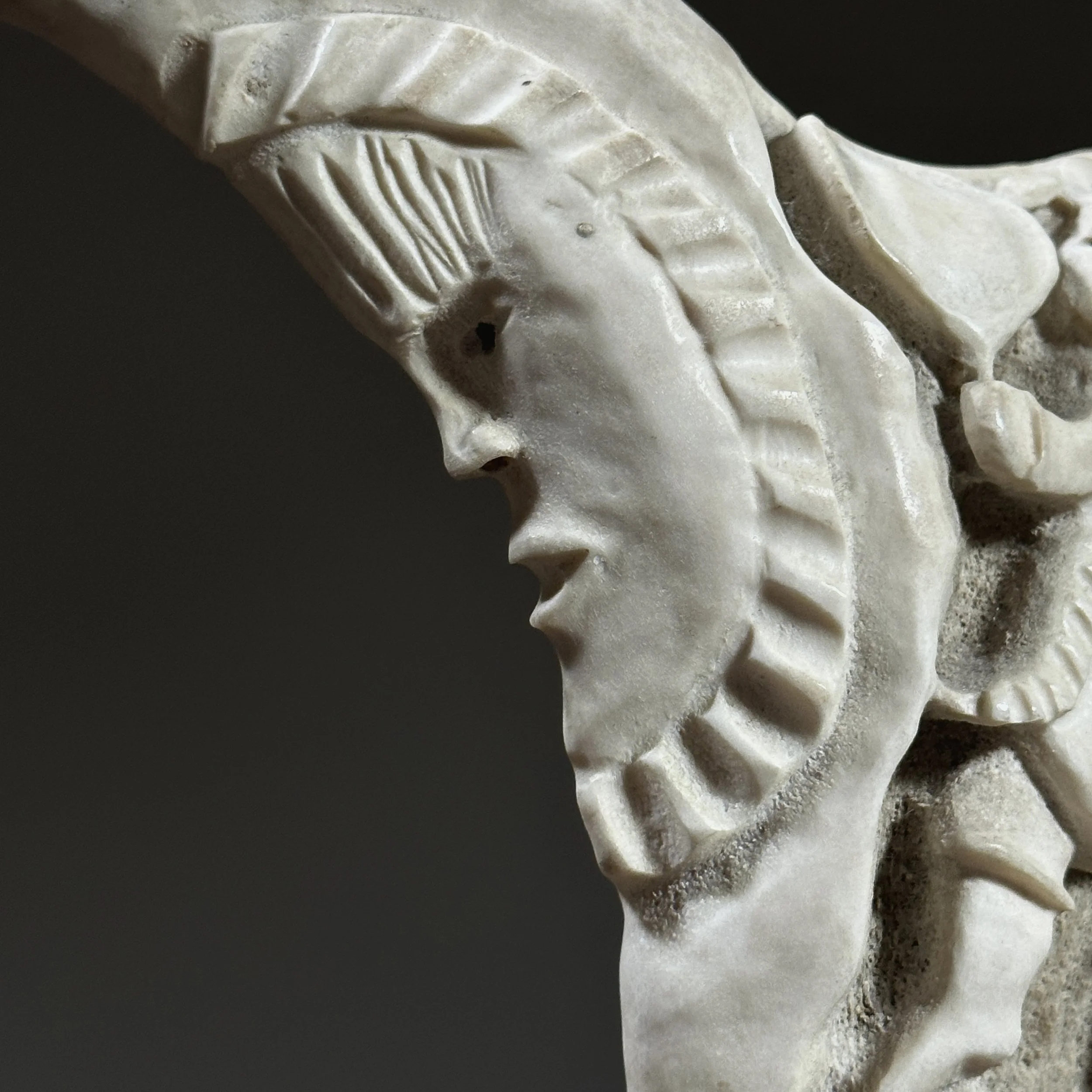 Close-up of the moon motif at the top of the composition.