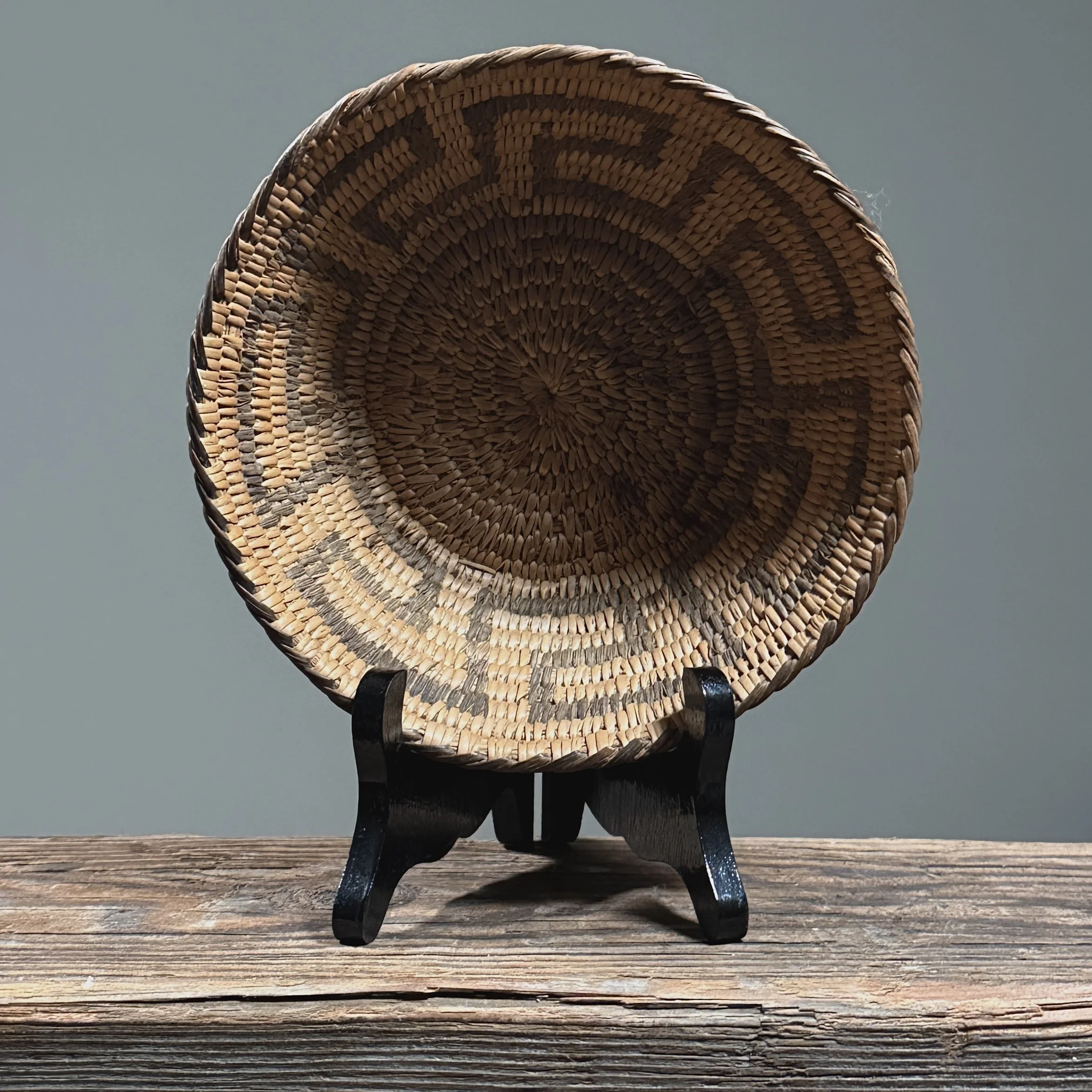 Top view of Pima basket. Circular opening. Geometric pattern radiating from center.