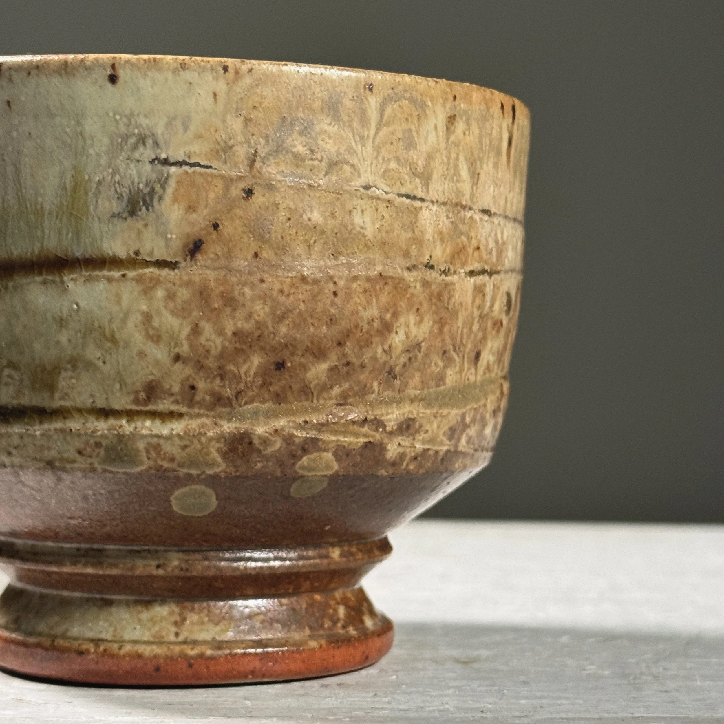 Angle emphasizing the interplay of ash and turquoise glazes.