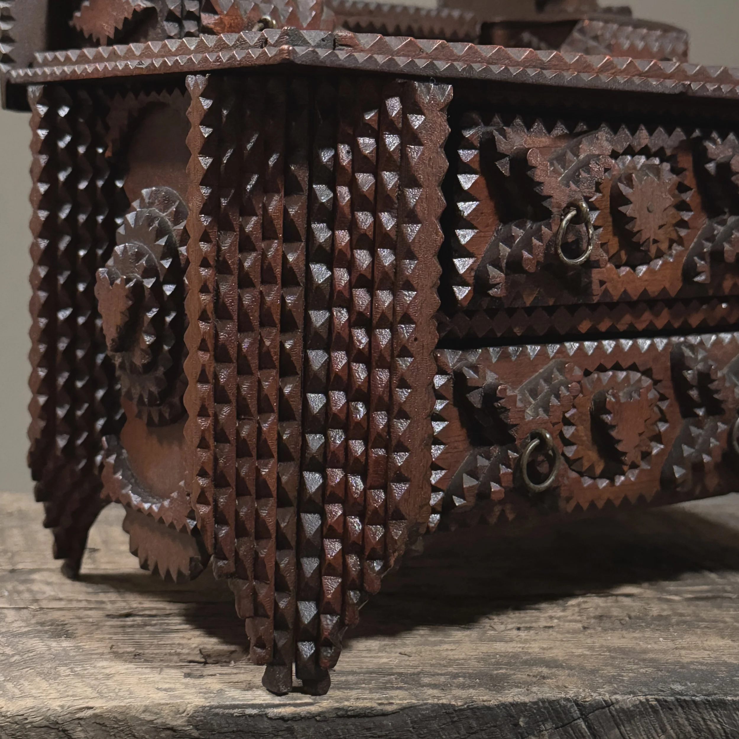 Corner detail showing stacked legs and layered carving technique