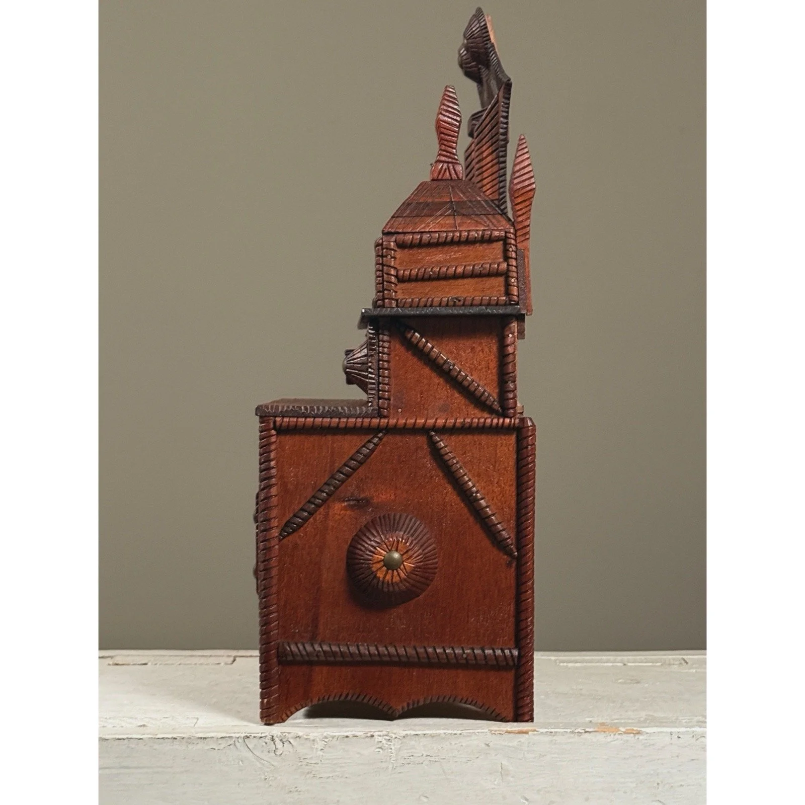 Side view highlighting carved knob ornamentation