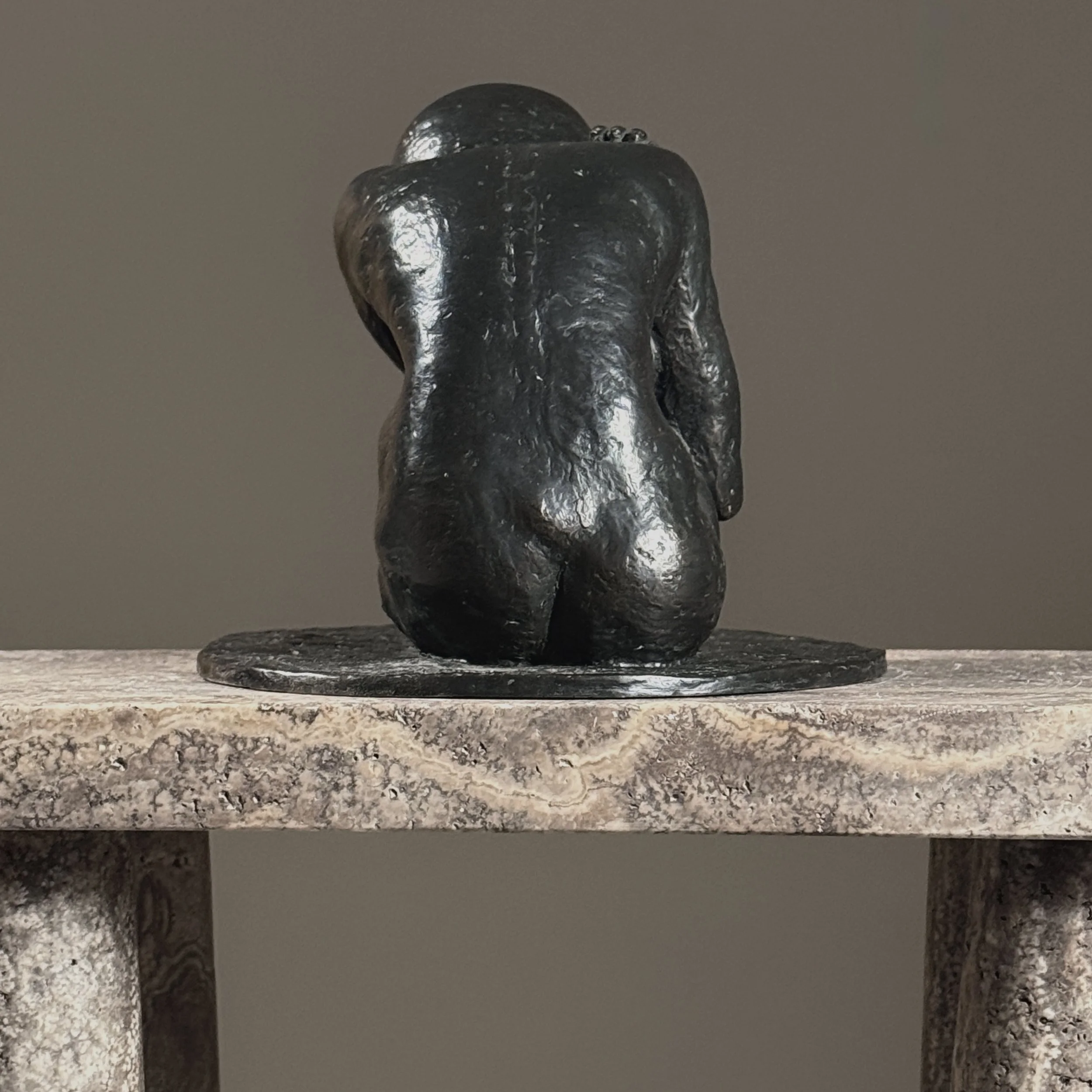Rear view of a realist bronze female nude demonstrating the artist's attention to sculptural form