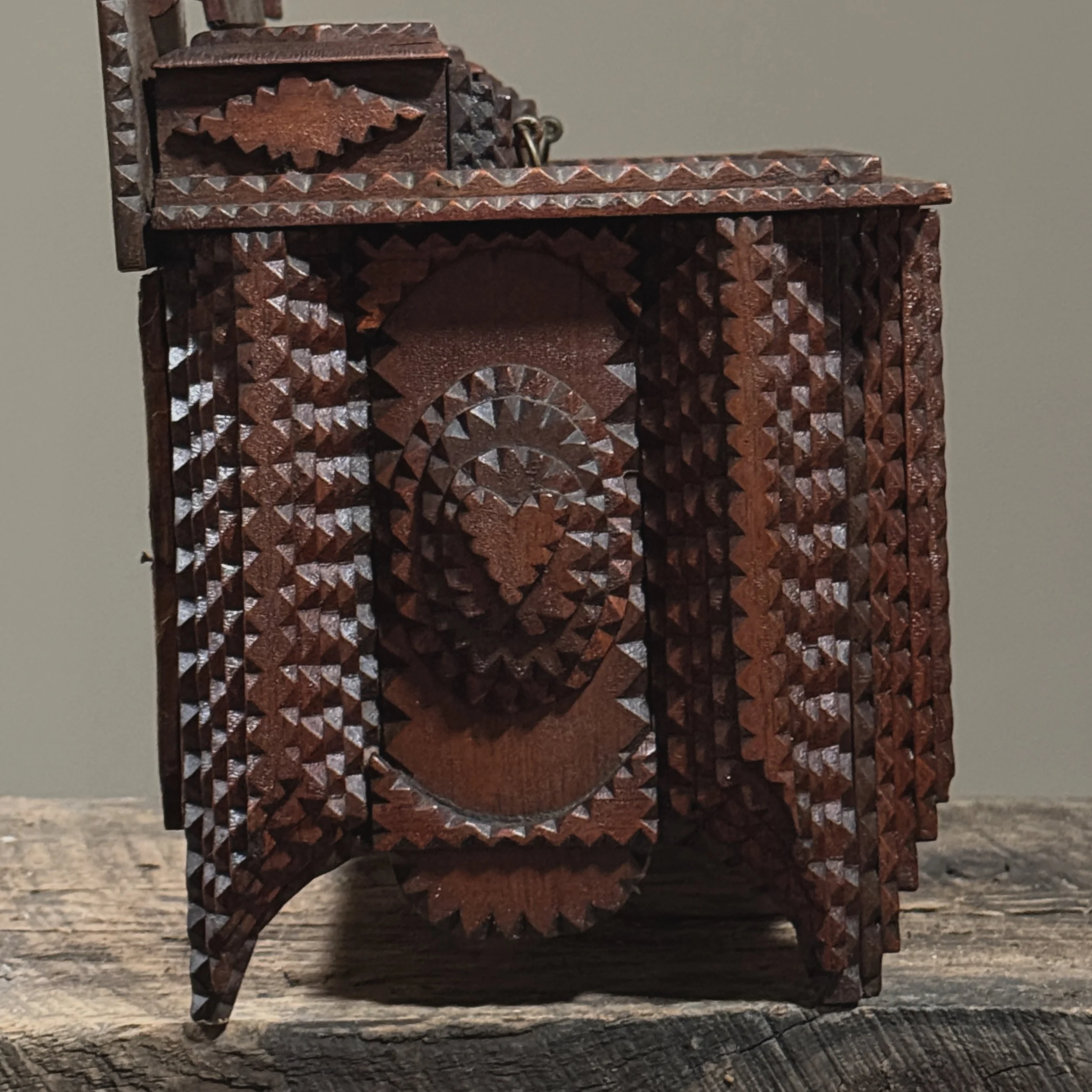 Gradual stepped carving leading to heart motif on dresser side