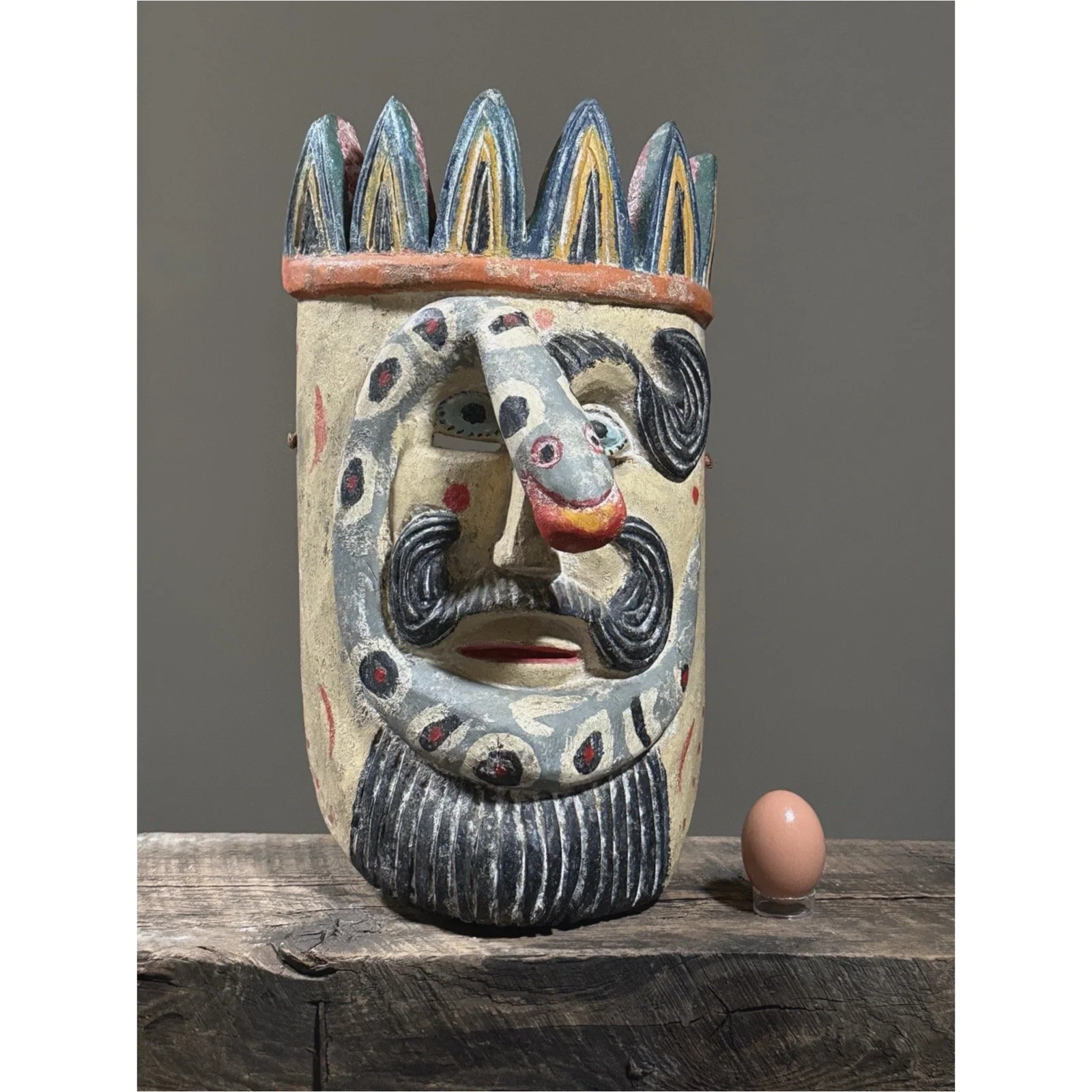 The mask displayed with an egg for size reference.