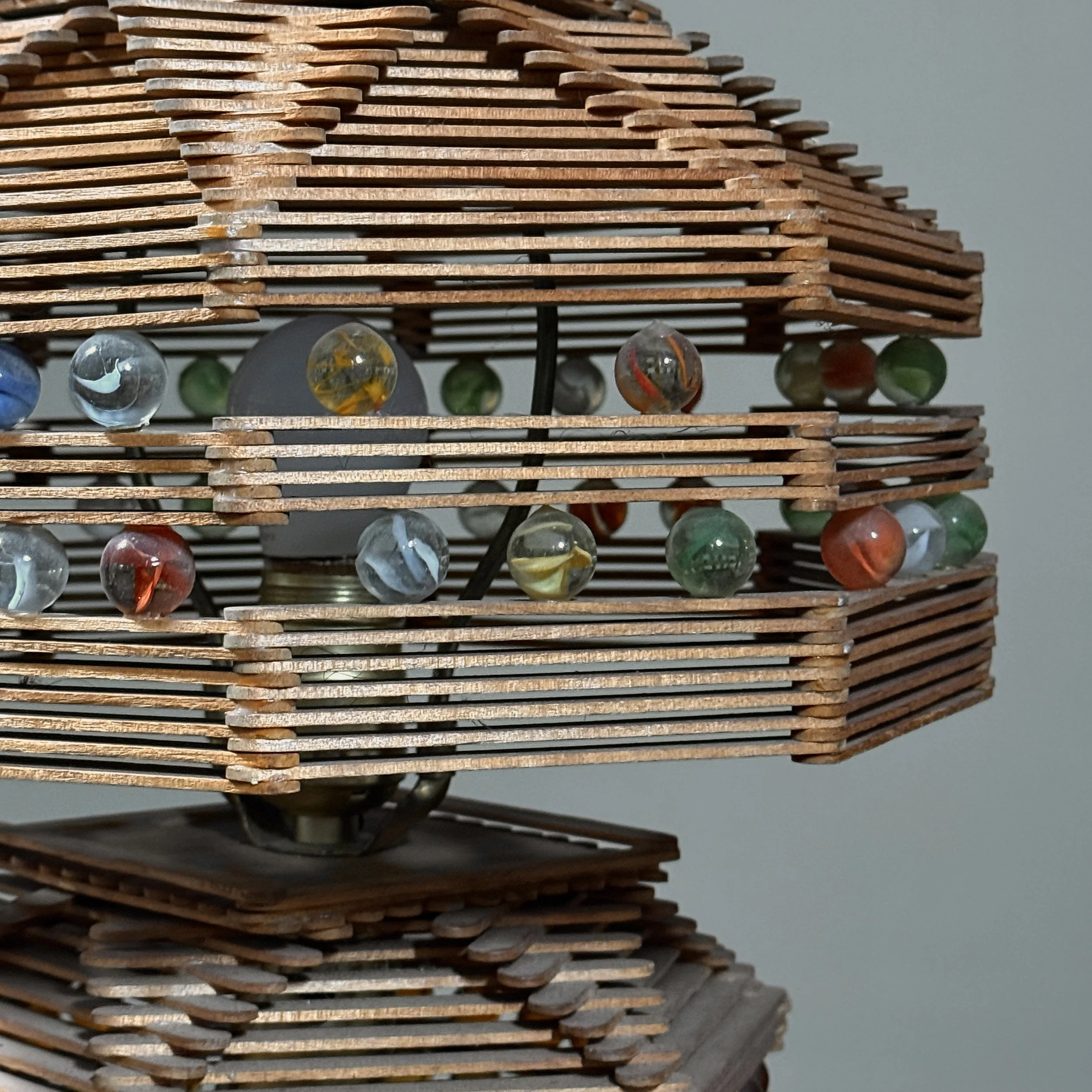 Macro detail of the popsicle sticks, showing glue residue, wood grain, and patina of age.