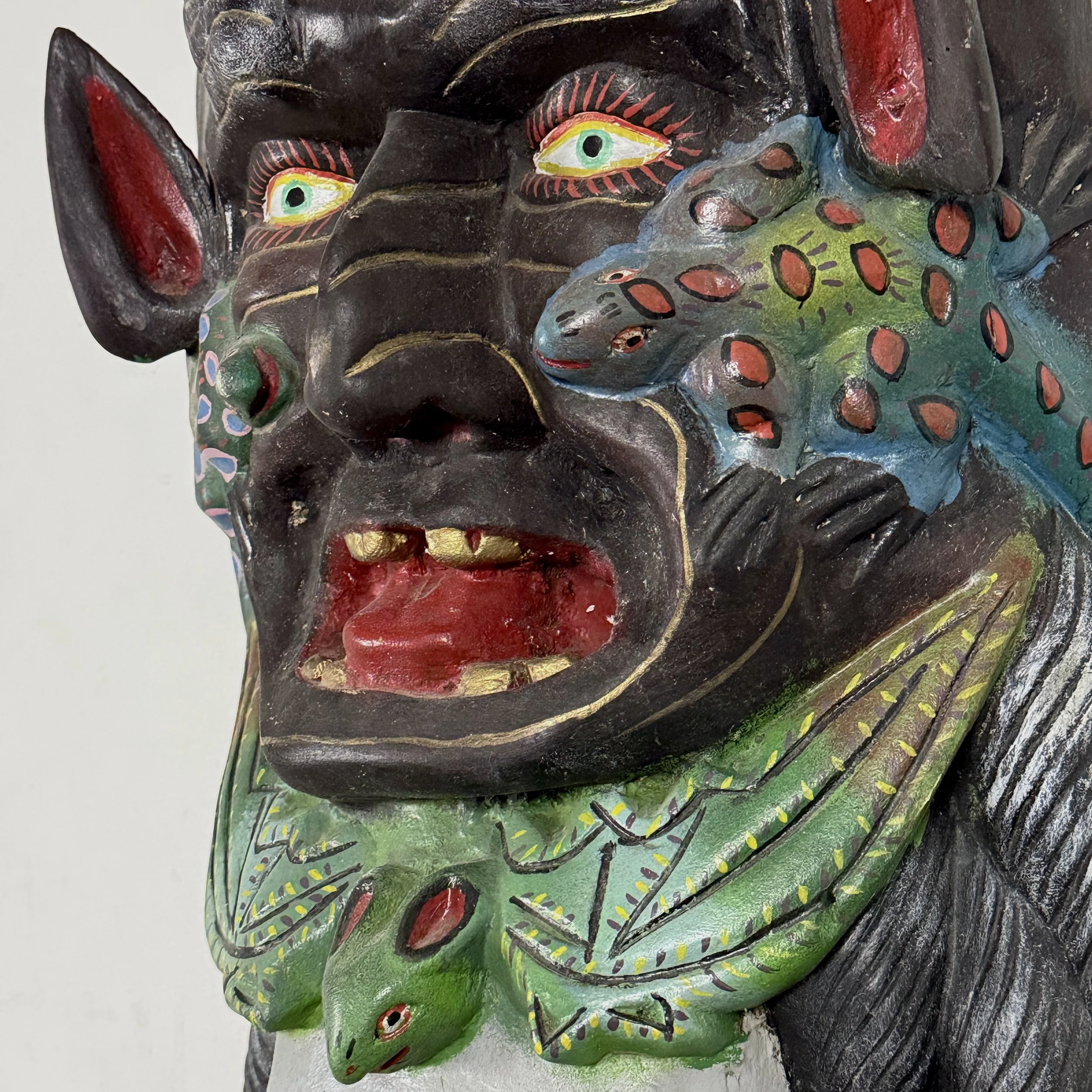 Detailed profile view of the devil.