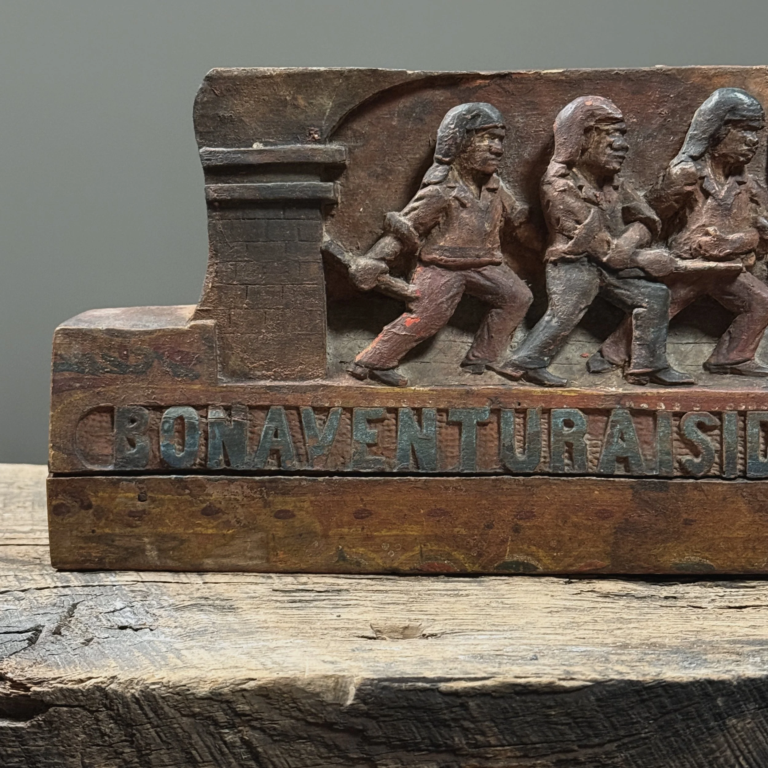 Detail of sword fight. Four male figures. Carved narrative composition.