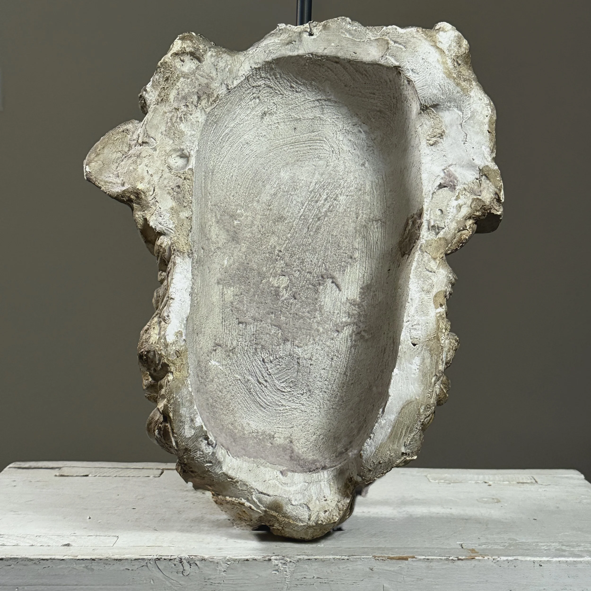 View from behind of the antique Silenus mask, showing the plain plaster back.