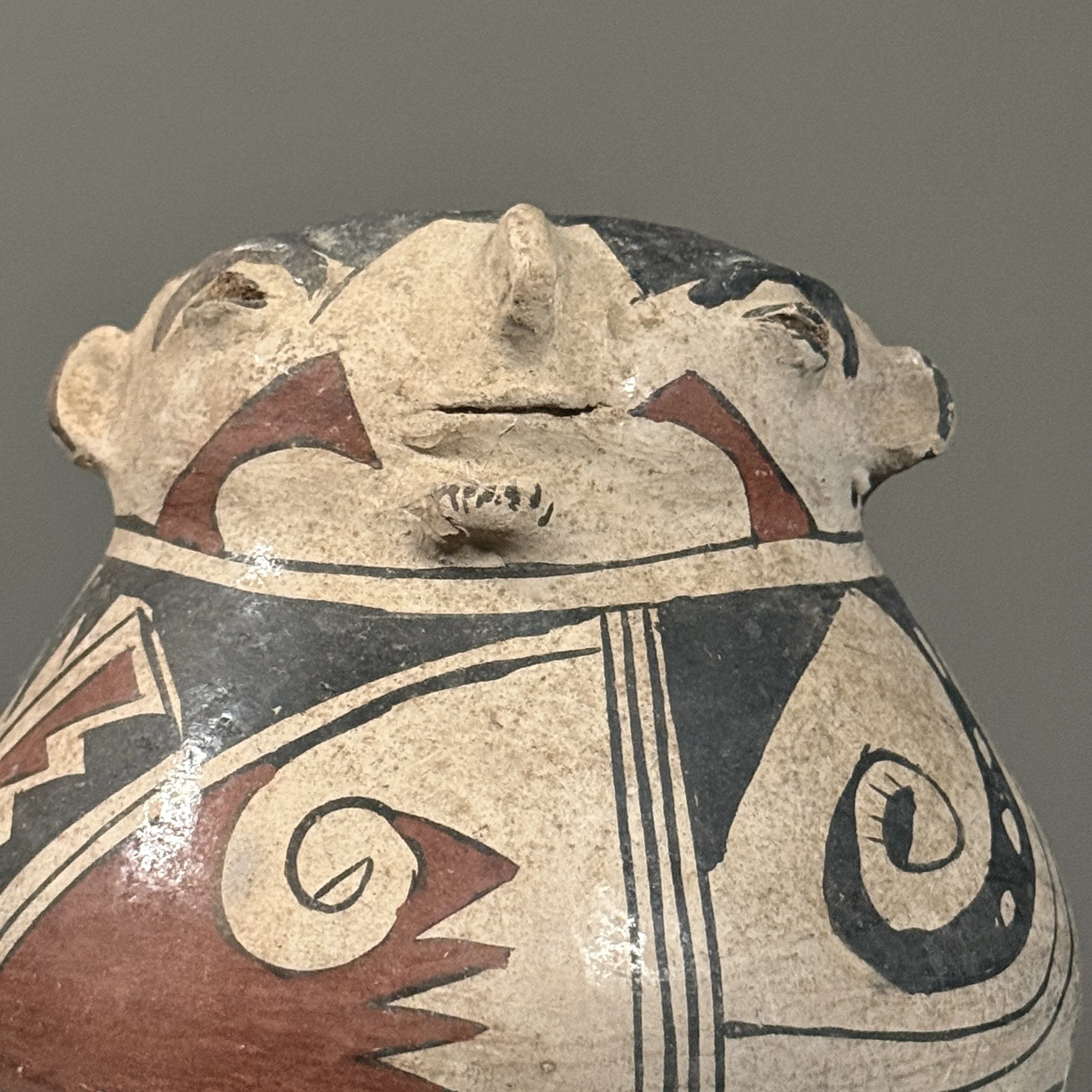 Close up of rim portrait on polychrome clay vessel