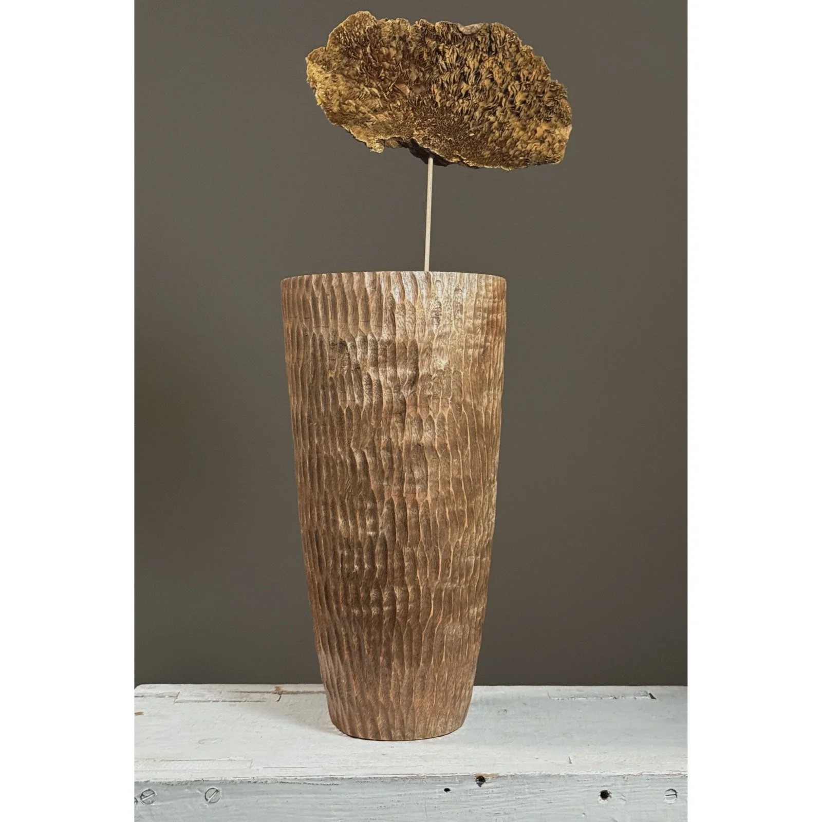 Front view of a vintage folk art chip-carved cylindrical wood vase.