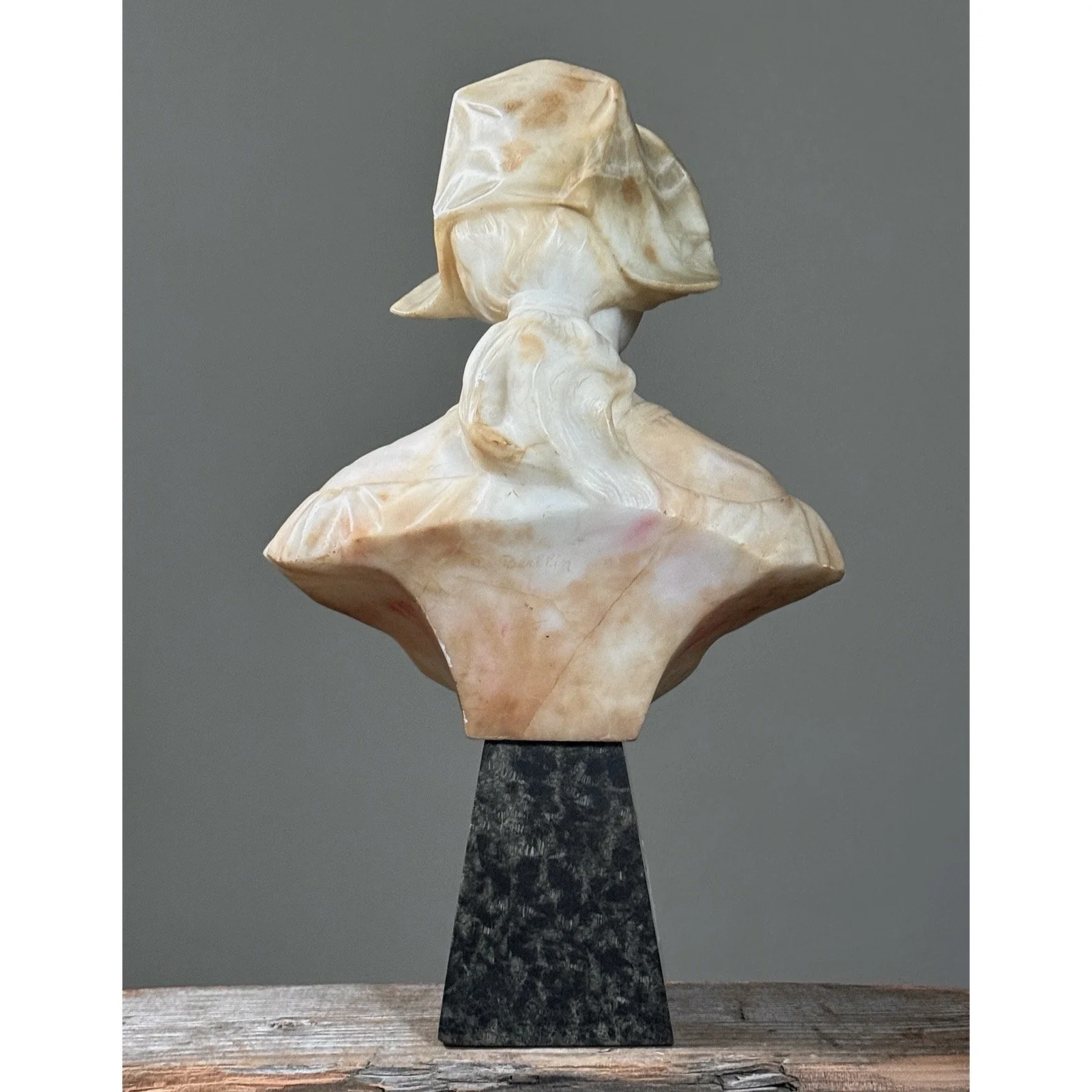 Rear angle of the sculpture showing the signature and the carving on the back.