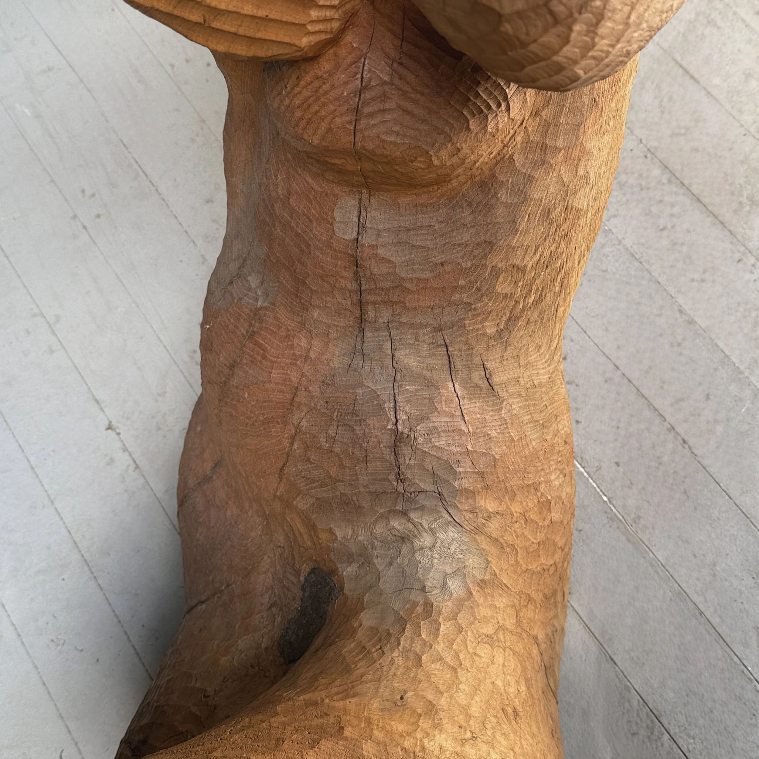 Elevated view looking down onto a monumental reclining figure sculpture