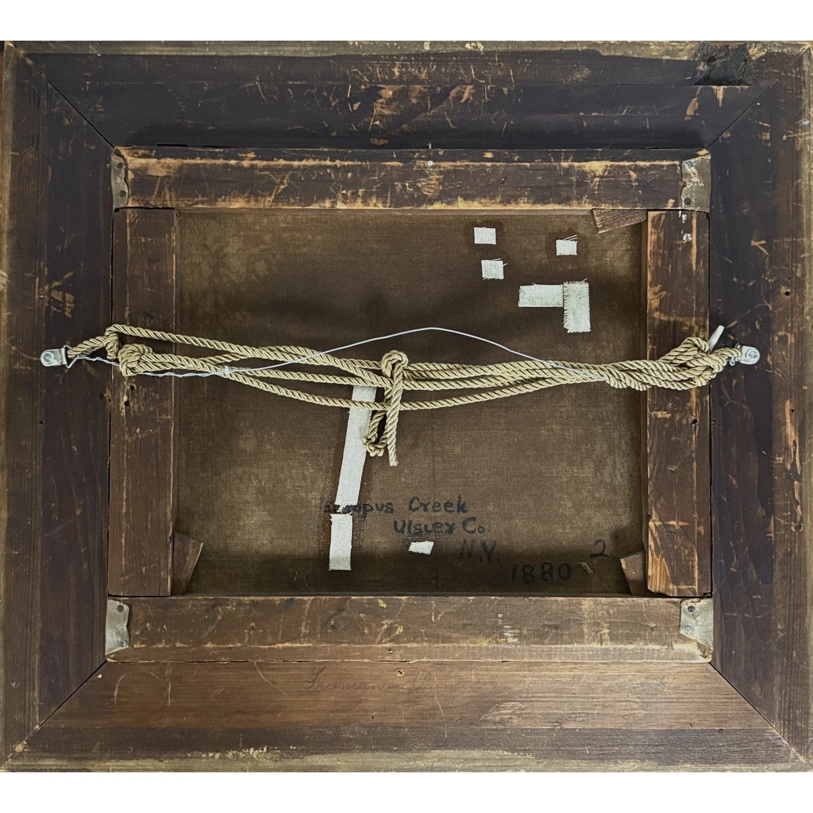 View of the painting's verso (back), showing canvas and stretcher bars.