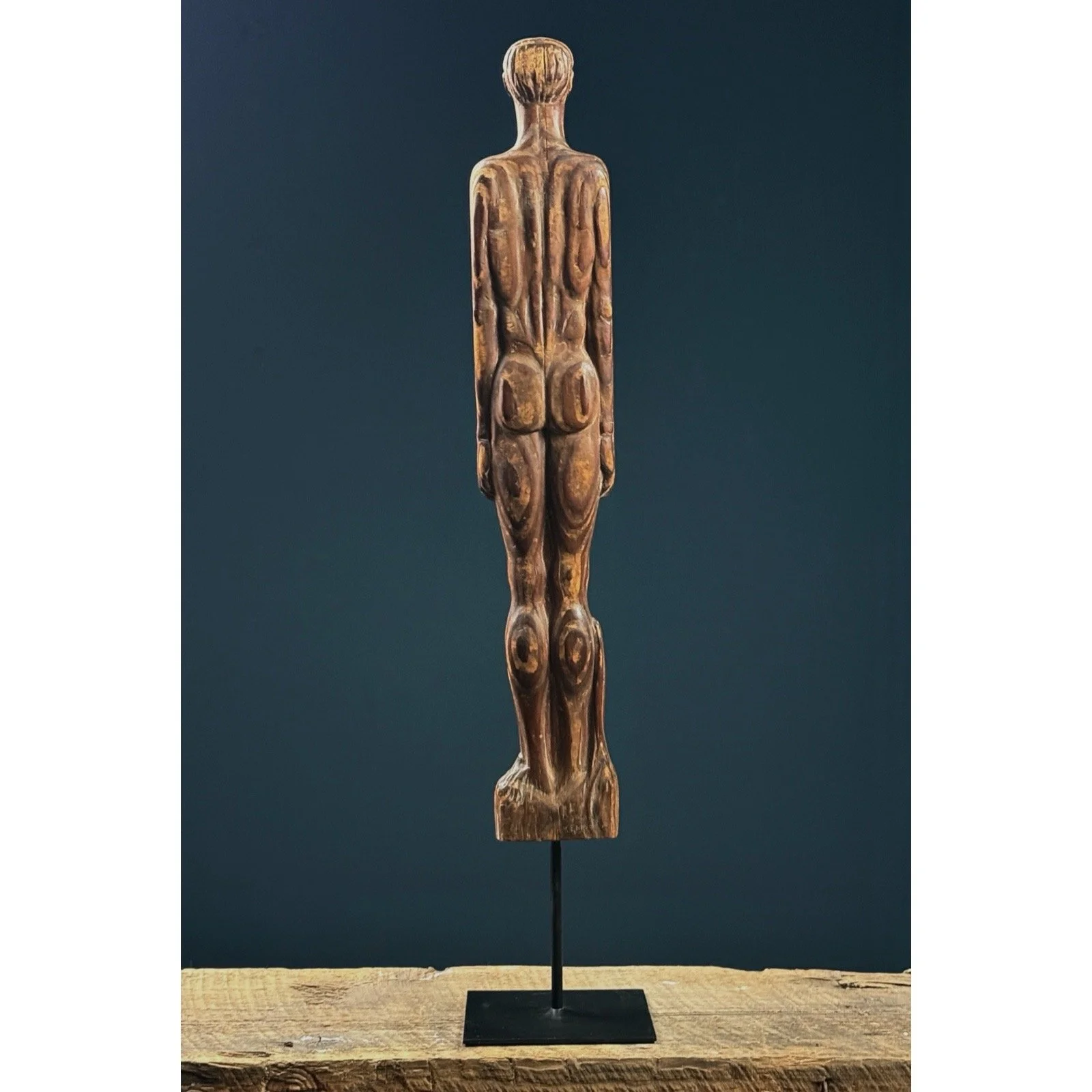 Rear view of the sculpture on its metal stand.