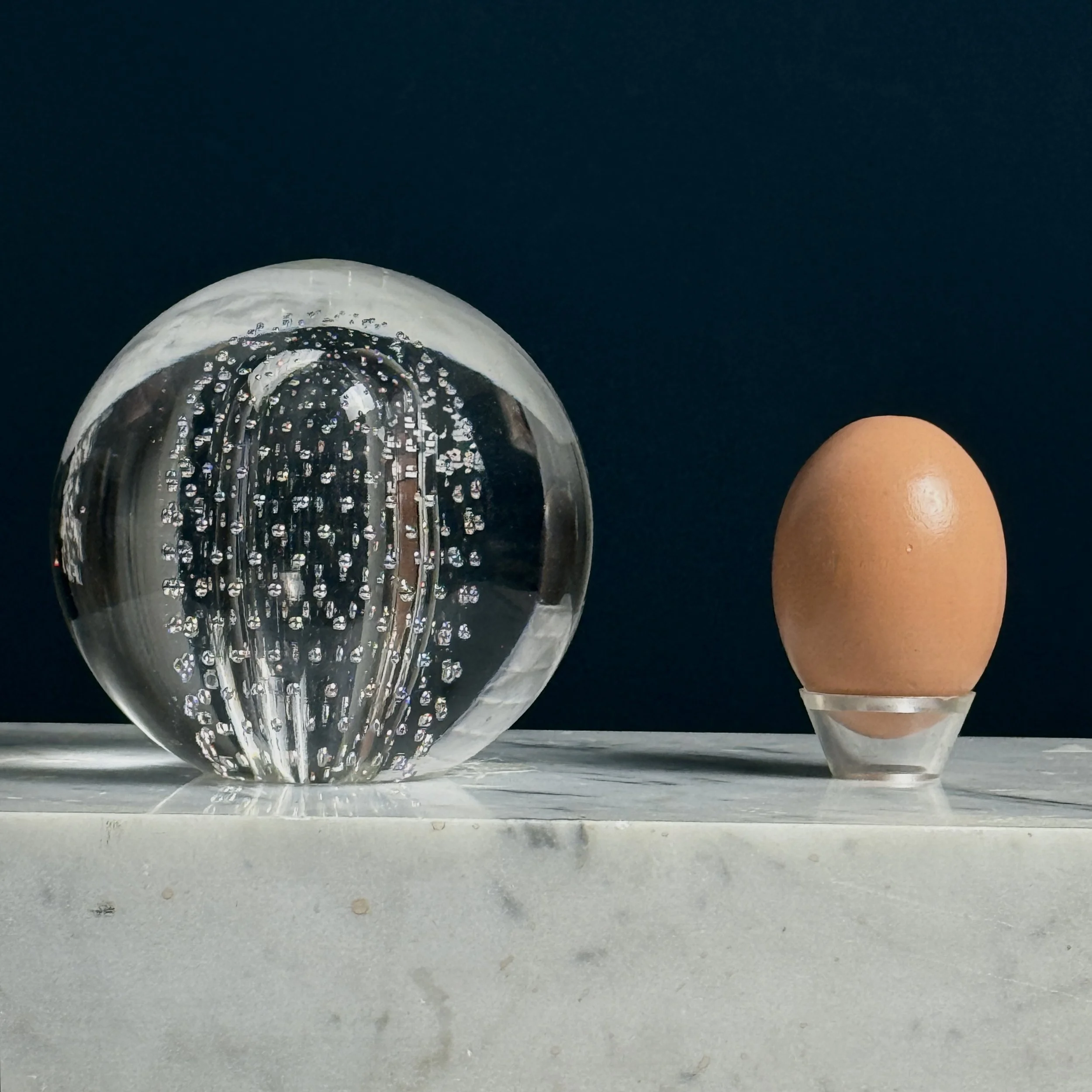 Paperweight with egg.