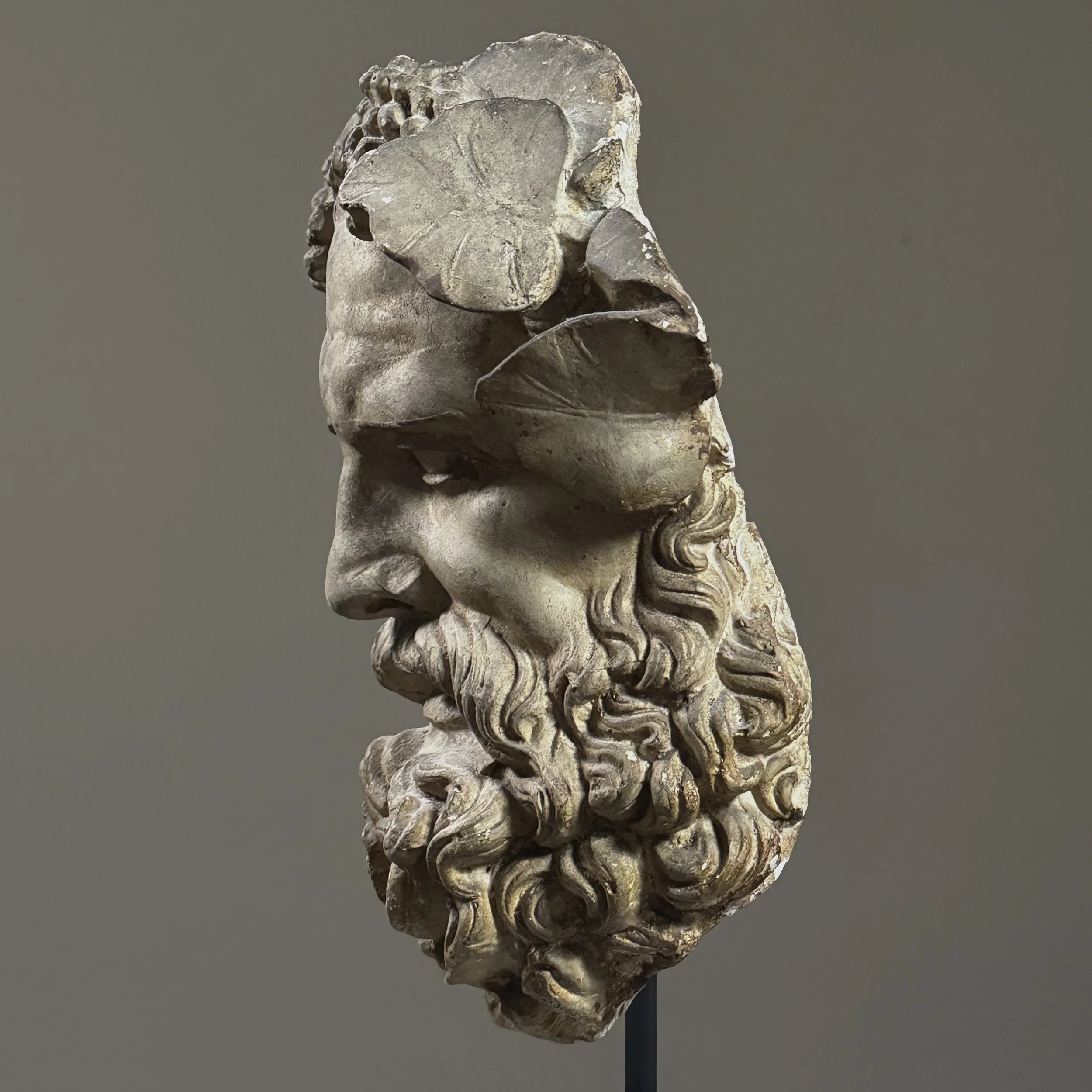 Profile side view of the antique Silenus mask showing depth and sculptural detail.