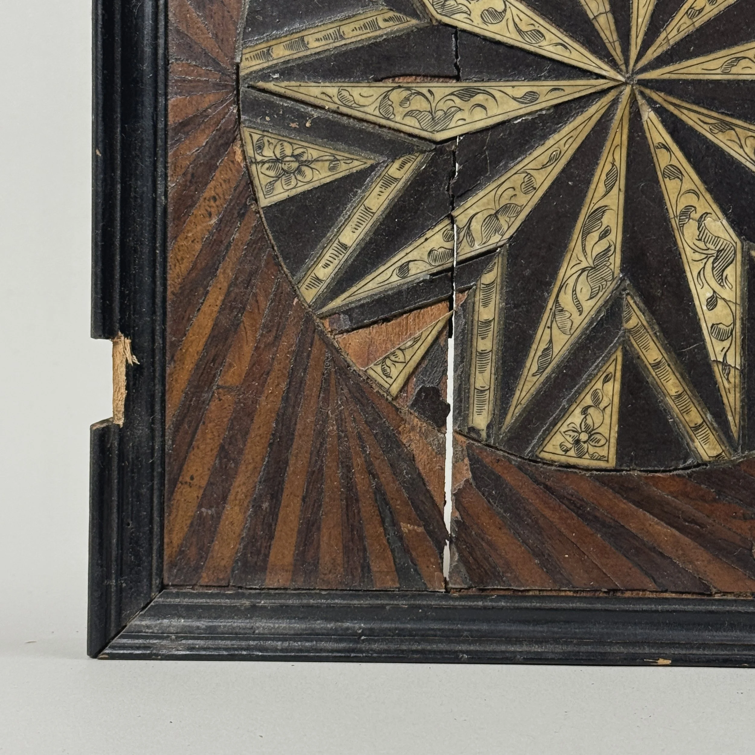 Sunburst detail. Geometric wood inlay. Symmetrical pattern.