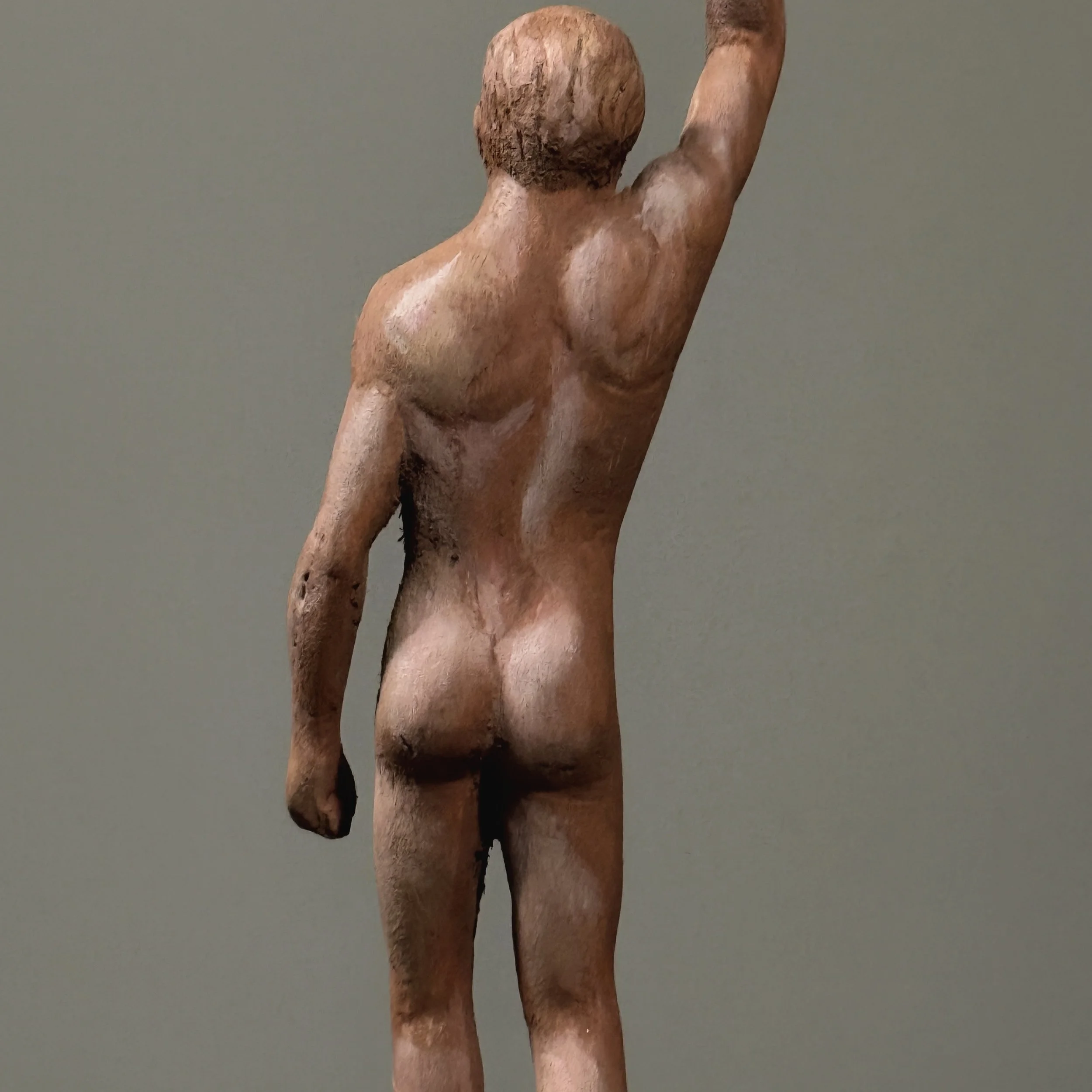 Small folk art male figure sculpture showing surface wear back detail.